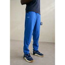 アンダーアーマー メンズ バスケットボール スポーツ LEGACY WINDBREAKER PANT - Outdoor trousers - tech blu...
