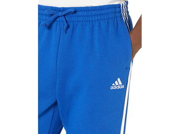 (取寄) アディダス メンズ adidas men Essentials 3-Stripes Tapered Cuff Fleece Pants Team Royal Blue/White