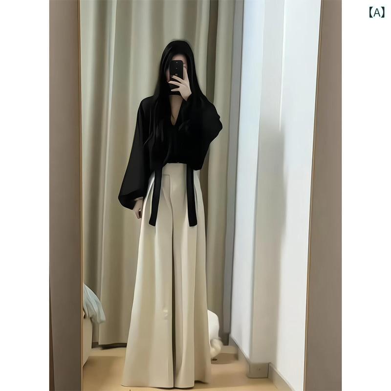 セットアップ レディース Vネック お 姉さんのは 黒い v ネックの 感の シャツ 上着を 着て ゆったりと しています。