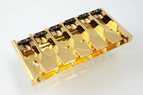 PRODUCT DETAILS ABM 3706-G ベース用 ブリッジ 6弦 ロックサドル ゴールド【商品仕様】・ ブランド：ABM・ 型番：3706-G (Allparts BB-3510-002)・ 品目：ベース用ブリッジ・ 対応弦数：6弦・ カラー：ゴールド・ 仕様：ロックダウン・サドル・ 調整範囲：3-1/4インチ 〜 3-1/2インチ【特徴】・ 6弦ベース用に対応したドイツABM社製のブリッジです。・ 各サドルをネジで固定できるロックダウン機構を採用しています。・ 弦振動を確実にボディへ伝える構造により、安定したピッチとサステインを提供します。【ご注意】・ 取り付けには加工・配線作業が必要な場合があります。お手持ちの楽器との適合（弦数・サイズ・取付穴位置）をご確認のうえご注文ください。・ アクティブタイプは9V電池が必要です（電池は付属しない場合があります）。 ■ 商品について 海外輸入品（説明書は英語表記の場合あり） ■ ご注意 ・掲載画像は実物に近い色味になるよう調整しておりますが、ご利用の環境により差異が生じる場合があります。・複数店舗で在庫を共有しているため、ご注文後に在庫切れとなる場合がございます。 ■ 納期について お届けの目安を必ずご確認ください。 海外正規ルート仕入れ品 海外ブランド ▼ 海外正規ブランド店 正規代理店 ▼ 当 店 ※本商品は並行輸入品です 製造元は正規品と同一のブランド・メーカーです。当店では海外正規ルートより仕入れた商品を取り扱っております。流通ルートが異なるのみで、商品自体に違いはございません。 ── 当店の商品について ── 正規品のみ取り扱い 海外正規店・正規代理店から商品を直接仕入れ、国内に輸入して販売しております。 日本未入荷・海外限定モデルも多数 日本未入荷・海外限定モデルも多数取り扱っております。サイズ・カラー違いや海外限定で販売された製品など、日本では手に入りにくいアイテムをお届けいたします。 お求めやすい価格の理由 海外市場での価格差や流通ルートの違いにより、国内販売価格よりお求めやすくなっております。品質はそのままに、よりお手頃な価格でお届けいたします。 安心保証 ご使用前に万が一、製品に不具合がございました場合は、交換または商品代金のご返金にて対応させていただきます。商品到着後5日以内にご連絡ください。 ご注意 海外からの輸入品となります。海外輸送のため、外箱に軽微なスレ等がある場合がございますが、商品本体には影響ございません。 ※在庫状況は仕入先の在庫情報をもとに出来る限り正確に表示しておりますが、取寄せ商品のため、タイミングによりご注文後に欠品・キャンセルとなる場合がございます。 お探しの商品がございましたら、お気軽にご相談ください。