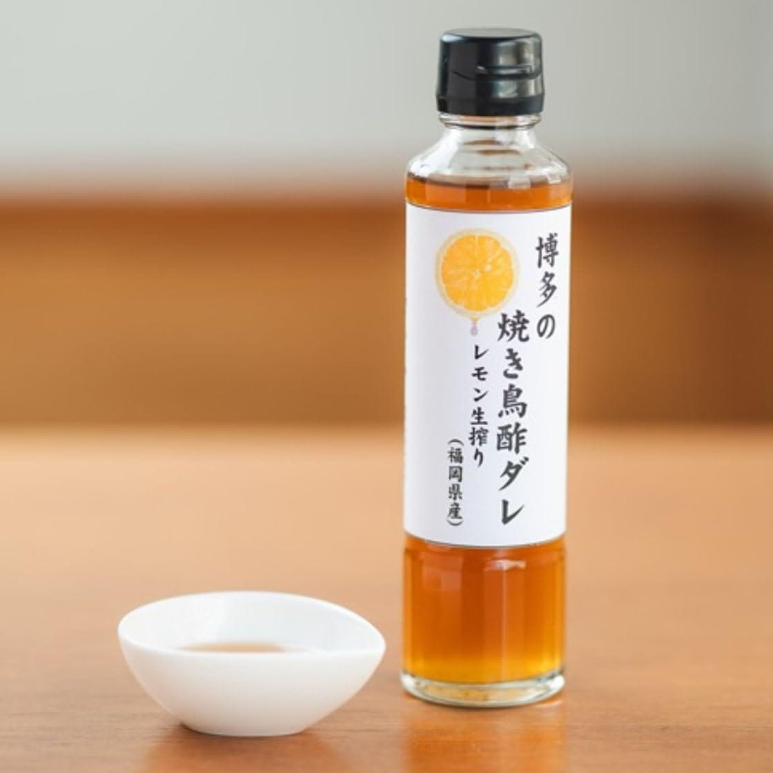 伝統製法: 福岡県産・鹿児島県産の厳選された原料を使用し、伝統的な製法で丁寧に醸造された焼き鳥酢ダレです完璧なブレンド: レモンの爽やかな酸味と醤油ベースの旨味が絶妙にマッチした特製タレです多目的利用: 焼き鳥はもちろん、から揚げや餃子、炒め物など様々な料理に活用できます便利な容量: 使いやすい200ml入りで、適量使用できる注ぎ口設計です保存方法: 開封後は冷蔵庫で保管し、3ヶ月以内にお使いください 福岡県産の新鮮なレモンを使用した贅沢な焼き鳥酢ダレです。さっぱりとした柑橘の風味と程よい酸味が、焼き鳥の旨味を引き立てます。この調味料は、伝統的な製法で丁寧に仕込まれ、焼き鳥はもちろん、から揚げや餃子など、様々な料理にも相性抜群です。透明感のある美しい琥珀色の液体は、食欲をそそる見た目も特徴的。程よい粘度があり、お肉にしっかりと絡みます。使いやすい注ぎ口の設計で、適量を簡単に調整できます。和食の定番調味料として、毎日の食卓に彩りを添える逸品です。保存料や化学調味料を使用せず、素材本来の味わいを大切にしています。冷蔵庫で保存することで、より長く風味を楽しむことができます。