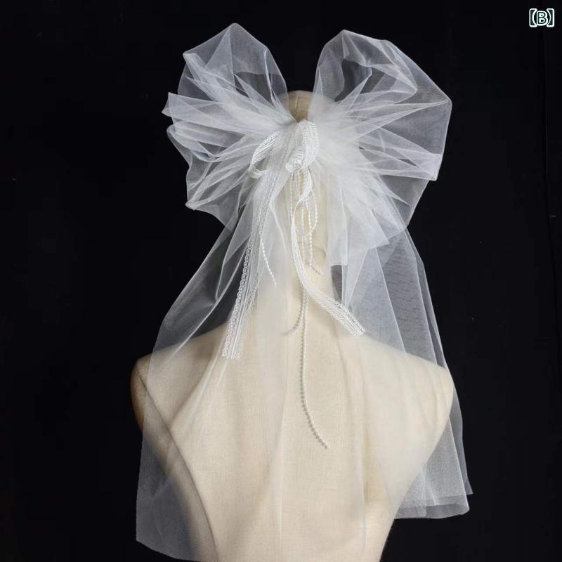 bloomelierのヘッドドレス レディース ブライダルベール 結婚式 花嫁 ロング丈 チュール生地 パールビーズ リボンモチーフ ラインストーン ウェディングフォト｜アングル2