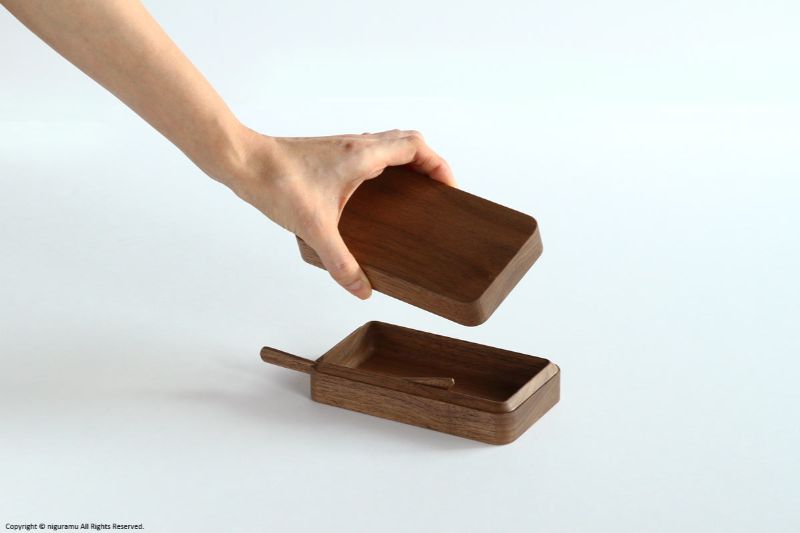 内側の角が削られ、中に45°入り込んでいるので、ふたを閉めたときのフィット感が抜群。無垢材をくり抜いた自然の風合いも心地いい名品です。チェリーやイタヤ（メープル）などの上質な木の質感がぬくもりを感じさせてくれます。

セットで付いているへら型バターナイフもすぐれもの。厚みや丸みが場所によって微妙に変えられているため、手にフィットし塗りやすさ抜群です。