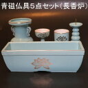 商品詳細 商品名 青磁仏具5点セット（長香炉） 長香炉・火立・花立・仏器・湯呑　各1個 香炉灰付 サイズ 長香炉　幅約193mm・奥行約66mm・高さ約62mm 　　　内部　幅上部約181mm・下部約160mm 　　　　　　奥行上部約53mm・下部約35mm 　　　　　　高さ約50mm 火立　直径約44mm・高さ約88mm 注）ロウソクは小ロウソクをご使用ください。 花立　直径約75mm・高さ約105mm 仏器　直径約50mm・高さ約57mm 湯呑　直径約50mm・高さ約54mm 材質 陶器製 詳細説明 通常の丸い香炉の代わりにお線香を二つに折らず寝かせられる長香炉に変更したセットになります。落ち着いた青に蓮の花が金色で描かれたオーソドックスな仏具です。 （火立のみ蓮の柄はございません。） 設置する目安としては上置き型のお仏壇サイズで、16号（高さが48cm前後）から23号（高さが69cm前後）までの小さめのお仏壇に最適のサイズとなっております。 大量生産品のため生産ロッドにより寸法に若干の誤差と、仏具の種類によって色味の違いが出る場合が御座います。 ＊送料に関しての注意事項 こちらの商品は地域別に送料が異なります。 ご注文前にご確認をお願いいたします。