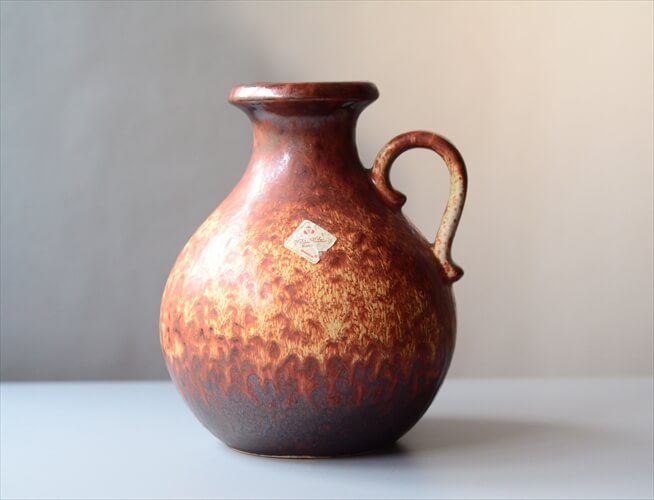 希少なドイツ・ミッドセンチュリー期の逸品！西ドイツ製ヴィンテージSheurichの陶器の花瓶です。1960-1970年代頃と思われるヴィンテージ陶器でジャーマン・アートポタリー German Art Potteryと称され世界的にファンやコレクターがいます。芸術性の高いデザインや雰囲気ある釉薬やテクスチャが大きな魅力ポイント！この年代のドイツ製陶器の多くが職人による手作業で製作されていたため全く同じ表情のお品が世界に2つとないと思われます。切り花や灌木など何気ない植物を挿すだけでも驚くほどの雰囲気の良さをもたらしてくれますが、その芸術性の高さから花や植物がなくても非常に絵になります。サイズ(cm)状態口径 8胴径 15高さ 20※若干の誤差はご了承ください。USED下部に画像のような欠けが見られます。商品の形状上、内側のクリーニングがしっかり行えない状態での販売となりますことをご了承ください。年数を経たヴィンテージということをご理解いただき味わいをお楽しみいただけますと幸いです。素材原産国陶器西ドイツ【送料無料】西ドイツ製 ヴィンテージ Scheurich窯 陶器の花瓶 Fat Lava 花器 一輪挿し ミッドセンチュリー期 フラワーベース アンティーク_240314希少なドイツ・ミッドセンチュリー期の逸品！西ドイツ製ヴィンテージSheurichの陶器の花瓶です。1960-1970年代頃と思われるヴィンテージ陶器でジャーマン・アートポタリー German Art Potteryと称され世界的にファンやコレクターがいます。芸術性の高いデザインや雰囲気ある釉薬やテクスチャが大きな魅力ポイント！この年代のドイツ製陶器の多くが職人による手作業で製作されていたため全く同じ表情のお品が世界に2つとないと思われます。切り花や灌木など何気ない植物を挿すだけでも驚くほどの雰囲気の良さをもたらしてくれますが、その芸術性の高さから花や植物がなくても非常に絵になります。サイズ・実寸値(cm)口径 8胴径 15高さ 20※若干の誤差はご了承ください。素材陶器原産国西ドイツ状態・注意点USED下部に画像のような欠けが見られます。商品の形状上、内側のクリーニングがしっかり行えない状態での販売となりますことをご了承ください。年数を経たヴィンテージということをご理解いただき味わいをお楽しみいただけますと幸いです。備考お店のトップに戻る