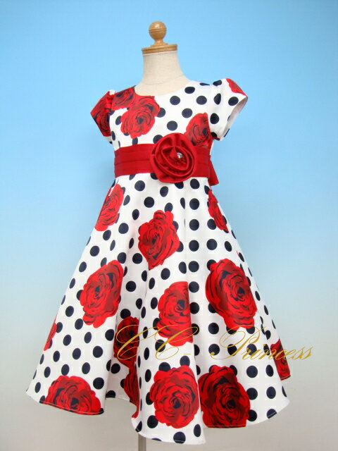 パニエ・L 【CC-PN-004】 1,875円 ラインストーンティアラ 【AC-C-043】 1,000円 黒のフォーマル帽子 【CC-HT-001】 2,800円 タイツ≪ウェーブライン≫ 【CC-SK-010】 500円 タキシード 【CC-BY-005】 6,500円 黒のスーツ 【CC-BY-003】 5,680円 ニッカボッカ 【CC-BY-029】 5,900円「 大き目ドットに大輪のバラがプリントされた華やかなドレス !! 」 ☆ ウエストのリボンにも大き目のコサージュ、後ろはリボン結びです。 ☆ スカートはチュール付きで、キュートにボリュームアップ　!! ☆ 女の子らしい、小さな可愛い、パフスリーブ、、 ☆ 姉妹でお色違いを選んでも素敵です、、 素材 ポリエステル お手入法 押し洗い手洗い サイズ表 サイズ 100cm 110cm 120cm 130cm 140cm 150cm 肩幅 25 25 25.5 26 26.5 28 胸囲 60 64 66 67 68 72 身丈 24 24 25 26 27 28 スカート丈 45 48 54 54 56 60 袖丈 9 9 9.5 9.5 10 10.5 総丈 69 72 79 80 83 88 ◆採寸時の注意点◆ サイズ表は平台において測ったサイズです。 多少の誤差がありますのでご了承下さい。 ☆「サイズの測り方」をどうぞご参考にして下さい。 ☆撮影時の光線の関係で多少実際の色と異なって見える場合がありますのでどうぞご了承くださいませ。 >>お買い物前に必ずお読みください