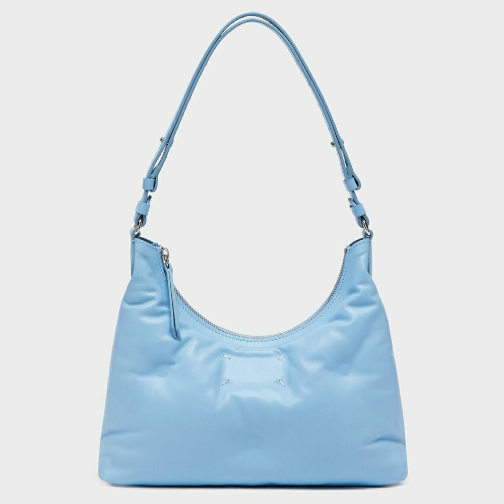 メゾン マルジェラ(Maison Margiela)は、フランスを拠点とするファッションブランド。 ウィメンズ・メンズウェア、アクセサリー、シューズ、フレグランスなど幅広く展開。 ブランド創業者のMartin Margiela（マルタン・マルジェラ）は、 名門アントワープ王立芸術アカデミーのファッション科の卒業生で、 アントワープ6（アントワープの6人）と呼ばれ、新しいファッションの流れをつくった伝説のデザイナーです。 2014年にJohn Galliano（ジョン・ガリアーノ）がクリエイティブ・ディレクターに就任し、 2015SSのオートクチュールコレクションをロンドンで開催しました。 これをきっかけに、ブランド名を「Maison Margiela(メゾン マルジェラ)」に改名しています。 【カラー】ライトブルー【品番】SB3WG0024P8840T6388【仕様】メゾンのコンセプトである「アンコンシャス・グラマー（無意識の魅力）」を、ソフトに丸みを帯びたホーボーシルエットで表現したバッグ。 キルティング加工のナッパレザーを使用したパッド入りの構造は、。 メゾンのアイコン「グラム スラム」ファミリーのアイテムで、フランス・マルセイユの伝統的なキルト技術「マトラッセ」を反映しています。 手持ちでも肩掛けでも、リラックスしつつも洗練されたフォルムを楽しめます。 フロントには、メゾンの「匿名性」を象徴する4本の白いステッチが施されています。 サイズ(cm)高さ：21 幅：6 長さ：28 ハンドルの高さ：35 ストラップの長さ：60 ※ショップ在庫と連動しておりますので、品切れの場合がございます。 予めご了承をお願いします。 ※こちらの商品は、ブランド直営店及び正規代理店からのお取り寄せ商品になります。 ※配送状況等によって、目安より到着が遅れることがございます。