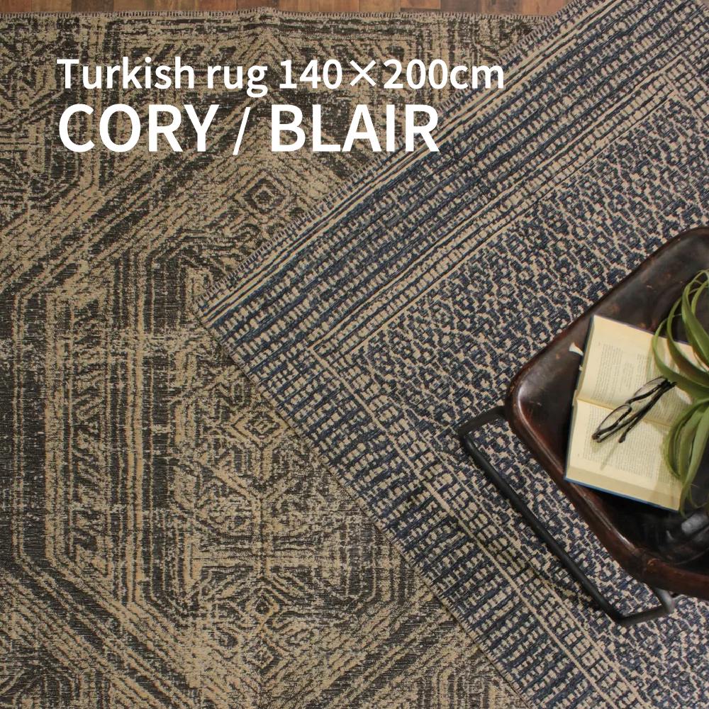 Item Spec 品　名Turkish rug CORY / BLAIR 120×170cm 特　徴 伝統的な絞り染めからインスピレーションを受けた模様を現代的にアレンジし、機械織りで再現しました。 肌触りの良いシェニール糸と天然ジュートを組み合わせて、耐久性にもこだわっています。 伝統とモダンが織りなす一枚です。 サイズ120×170cm 材　質ジュート53％、ポリエステル33%、ポリプロピレン14％ 原産国トルコ 備　考● ホットカーペット、床暖房OK ● ご家庭での洗濯はできません。 　クリーニング店にご相談ください。 ● 本製品は手作業で作られております。 　 製品ごとに寸法や形状が多少異なりますのでご了承ください。 ● 天然素材の風合いや一点一点異なる造りも含めて商品の持ち味となっておりますのでご理解をお願いいたします。 ● 汚れた場合は、固く絞った布に薄めた中性洗剤を含ませ、叩くように拭き、その後水洗いした布で洗剤を拭き取り、最後は乾拭きで陰干ししてください。 ● 誤配送、初期不良品以外の返品交換は承っておりません。 ●開封直後、素材特有の匂いなど感じることがあります。 　その際は風通しの良い日影に2-3日干してください。 ● お手入れ方法の詳細は商品ページの 　「HOW TO CARE」をご確認ください。 ● モニターやデバイスにより実物と色味が異なって見える場合がございます。 ● 北海道および沖縄・離島への配送は別途送料が必要となります。 ● 在庫が確保できない場合がございます。 　ご注文後メールにてご連絡いたします。 キーワードラグマット カーペット センターラグ ソファラグ 織物 長方形 120×170cm 1.5畳相当 6～8畳用 ハンドメイド おしゃれ かわいい ラグ 人気 幾何柄 抽象柄 絞り染め風 BOHO ダイニング 寝室 ベッドサイド ソファ前 リビング用 人気 おすすめ 海外インテリア トレンド 北欧 ナチュラル レトロ ヴィンテージ カジュアル ミッドセンチュリー ブルックリン 床暖房対応 リビング ワンルーム 一人暮らし 新築祝い 引っ越し祝い 模様替え ラグのある暮らし 北欧 暮らし ダッパーズルーム お取り扱いのご注意 ・直射日光の当たる場所に長時間放置しないでください。 ・濡れた状態での保管はお避けください。 ・ご使用中の摩擦による色落ち、色移りにご注意ください。 ・製品の特性上、糸が輪っかの状態で飛び出してしまう事があります。 　無理に引っ張らず、ピンセット等で両サイドを優しく埋めてください。 ・切れた糸・布は表面に近いところで、はさみを使ってカットしてください。伝統を、いまの空間へ 絞り染めから着想を得た、どこか懐かしくも新しい模様。 それを現代の空間に馴染むよう、再構築した一枚。 伝統とモダンが交差することで、“ただのラグ”では終わらない存在感が生まれます。 ネイビー｜静けさの中に、奥行きを 深みのあるネイビーの「CORY」は、空間に落ち着きを与える色。 主張しすぎず、それでいて確かな存在感を持ちます。 6畳のリビングではソファや木家具と自然に調和し空間を引き締め、8畳では余白を活かしながら、上質な雰囲気をつくります。 ブラック｜空間を引き締めるアクセント ブラックの「BLAIR」は、空間の輪郭を際立たせるカラー。 モダンやインダストリアルなインテリアと相性がよく、空間にメリハリを生み出します。 広すぎず、狭すぎない6畳では、暮らしにちょうどいい“主役ラグ”です。 8畳の空間では、ラグを敷くことでゾーニングが生まれ、シンプルな部屋に取り入れるだけで、ぐっと洗練された印象へと変わります。 異素材が生み出す、心地よさ 肌触りの良いシェニール糸に、天然ジュートを組み合わせた構造。 やわらかさと耐久性、そのどちらも妥協しない仕上がりです。 素足で触れたときのやさしさと、長く使える安心感を兼ね備えています。 日常にちょうどいいサイズ感 120×170cmの扱いやすいサイズ。 ソファ前やセンターラグとして、空間にちょうどよく収まります。 一人暮らしの部屋からファミリーのリビングまで、幅広いシーンで活躍するバランスの良い一枚です。 季節を問わず、快適に ホットカーペットや床暖房にも対応。 寒い季節も快適に使える実用性を備えています。 季節を選ばず、オールシーズン使えることで、暮らしの中に自然と溶け込んでいきます。 トルコ製が生み出す、確かな品質 ラグの産地として知られるトルコで生産。 機械織りによる安定した品質と、デザイン性を両立しています。 見た目だけでなく、日常使いに耐える安心感も、このラグの大きな魅力です。 暮らしに、少しだけ個性を シンプルすぎず、派手すぎない。 その絶妙なバランスが、空間にちょうどいい変化をもたらします。 敷くだけで、部屋の印象が変わる・・・そんな“効く一枚”として、取り入れてみてください。 【※必ずご確認ください※】 ＜カラー・サイズについて＞ ※商品画像はできる限り実物に近づけ撮影しておりますが、ご使用のデバイス・モニター設定 　日当たりや照明などにより実際の色味と違って見える場合がございます。 ※サイズの計測は一定の基準をもって計測しておりますが、商品によっては若干の誤差が生じ 　る場合がございます。 ＜在庫・送料・配送について＞ ※当店およびメーカーの在庫状況は刻々と変動しております。 　ご注文のタイミングによっては在庫を確保できない場合がございます。 　注文後にメールまたはお電話にてご連絡させていただきます。 ※「送料無料」と表示している場合でも、北海道、沖縄および離島への配送は別途費用が必要と 　なる場合がございます。 ※商品によって、お届け日は商品ページに記載しているお日にちよりも日数を必要とする場合が 　ございます。 　配送エリア・梱包準備・大型商品や受注商品などの特殊事情による配送手配により変動いたし 　ます。 　あらかじめご理解、ご了承いただきますようお願いいたします。 ※開梱・組立および設置サービスは承っておりません。 　また、以下のような事例に関し、弊社は一切の費用負担と責任を負いません。 　同様に返品・交換のご要望をお受けすることもできかねます。 　・ご注文時のお客様情報の登録間違いに起因するお届け商品の転送費用や返品。 　・搬入経路確認が不十分であったことに起因する搬入にかかわる追加費用や返品。 　・商品のお受け取りを長期間なされず、返送に要した費用はお客様に請求させていただきます。 ＜在庫・送料・配送について＞ ※イメージ違いやサイズ違いによる返品・交換は固くお断りいたします。 ※商品の到着後、すぐに商品のご確認をお願いいたします。 ※返品・交換は初期不良に限りお受けいたします。 ※返品・交換をご依頼いただく際、破損または不良と思われる部分の画像を必ずご提供ください。 　画像のご提供をいただけない場合は、返品・交換のご依頼に応じることはできません。 ※商品の返品・交換による返送には商品の再梱包が必要となります。 　梱包されていない商品は、運送会社様にて受け取りを拒否されます。 　ご協力をお願いいたします。 ※無断で返送された場合、ご購入代金の返金はいたしかねます。 　また、顧問弁護士を通じ返送費用を請求させていただきます。