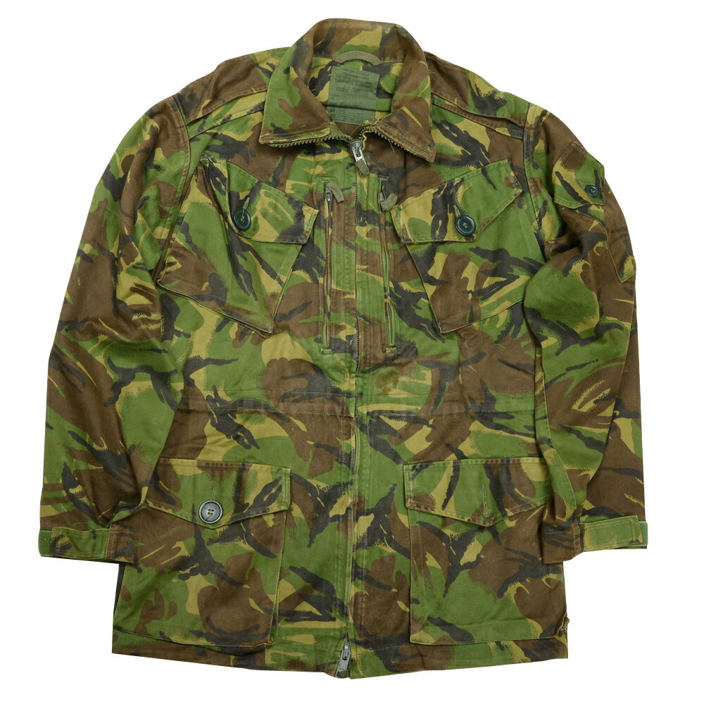 British Army Jacket 払い下げ品 コンバットスモック大きなポケット多数で収納部が充実。英軍用迷彩柄ジャケット■軍放出品のご購入を検討されているお客様へ。ご購入前に必ず下記の説明文、注意文を最後までご一読いただきますようお願い致します。イギリス軍より払い下げられた「SMOCK COMBAT TEMPERATE DPM」です。フロントに6つの大きなポケットが搭載されている他、左肩には小物入れとペンホルダー、さらに内側の腰部分もポケット状になっており、大・小様々なものを分別収納できるよう設計されています。フードは搭載されておらず、フロントの開閉もファスナーだけのオーソドックスなデザインです。カラーは、1968年から採用されているイギリス軍独自の迷彩パターン「DPM」。一般的なウッドランドカモに比べ、より生い茂った植物をイメージさせるようなデザインで、密林地帯などで高い迷彩効果を発揮します。素材はコットン/ナイロンの混紡生地製で、ゴワつきの少ない柔らかな肌触りとなっています。下記をお読みになり、ご納得いただけるお客様のみ、ご購入下さい。軍放出品（ミリタリーサープラス）は状態によって、下記の分類をしています。1，デッドストック　「新古品・未使用品（ほぼ新品）」2，良い　「キズや使用感があまり見られない。」3，可　「使用感があり、小さな傷等がある。」4，難あり　「比較的大きな傷、汚れがある。」5，破損あり「破損はあるものの、使用できる状態」6，ジャンク品「破損があってそのままでは使用できない」※製造年代、色合い、その他、ご指定できません。※ご購入後に商品の状態に関するお問合わせはお受けできません。※ご購入後に返品、交換をご希望の場合、発生する送料はお客様のご負担になります。実際のサイズは、2cm前後の誤差がある場合がございます、あらかじめご了承ください。 ※製品の仕様、外観はメーカーより予告なく変更されますので、気になる点や、詳細はメールで別途お問合わせください。PC・モニタの環境で色が実物と多少異なる場合があります。布製品などは個体差があり、寸法に誤差が多少ありますので、ご了承くださいませ。ジャケットの詳細こちらは「イギリス軍放出品 スモック SMOCK COMBAT TEMPERATE DPM迷彩 [ 180/104 / 破損あり ]」のご購入ページです。【サイズ:160/88】 着丈:約70cm・肩幅:約47cm・身幅:約57cm・袖丈:約57cm・袖幅:約18cm・重量:約1kg【サイズ:160/96】 着丈:約73cm・肩幅:約50cm・身幅:約65cm・袖丈:約55cm・袖幅:約19cm・重量:約1kg【サイズ:160/104】 着丈:約73cm・肩幅:約52cm・身幅:約64cm・袖丈:約55cm・袖幅:約19cm・重量:約1kg【サイズ:170/88】 着丈:約76cm・肩幅:約46cm・身幅:約55cm・袖丈:約59cm・袖幅:約17cm・重量:約1kg【サイズ:170/96】 着丈:約79cm・肩幅:約48cm・身幅:約61cm・袖丈:約61cm・袖幅:約19cm・重量:約1.1kg【サイズ:170/104】 着丈:約79cm・肩幅:約52cm・身幅:約64cm・袖丈:約61cm・袖幅:約19cm・重量:約1.1kg【サイズ:170/112】 着丈:約79cm・肩幅:約54cm・身幅:約68cm・袖丈:約61cm・袖幅:約19cm・重量:約1.1kg【サイズ:180/96】 着丈:約85cm・肩幅:約51cm・身幅:約65cm・袖丈:約66cm・袖幅:約19cm・重量:約1.1kg【サイズ:180/104】 着丈:約85cm・肩幅:約51cm・身幅:約65cm・袖丈:約66cm・袖幅:約19cm・重量:約1.1kg【サイズ:180/112】 着丈:約85cm・肩幅:約56cm・身幅:約68cm・袖丈:約66cm・袖幅:約19cm・重量:約1.2kg【サイズ:190/104】 着丈:約78cm・肩幅:約52cm・身幅:約62cm・袖丈:約69cm・袖幅:約18cm・重量:約1.3kg【サイズ:190/112】 着丈:約88cm・肩幅:約56cm・身幅:約67cm・袖丈:約71cm・袖幅:約19cm・重量:約1.2kg【サイズ:190/120】 着丈:約90cm・肩幅:約56cm・身幅:約67cm・袖丈:約62cm・袖幅:約20cm・重量:約1.3kg他のバリエーションはこちら[ 160/104 / 可 ][ 160/104 / 破損あり ][ 160/88 / 可 ][ 160/96 / 可 ][ 170/104 / 可 ][ 170/104 / 難あり ][ 170/112 / 難あり ][ 170/112 / 可 ][ 170/88 / 難あり ][ 170/88 / 可 ][ 170/88 / 破損あり ][ 170/96 / 難あり ][ 170/96 / 可 ][ 180/104 / 破損あり ][ 180/104 / 可 ][ 180/104 / 難あり ][ 180/112 / 可 ][ 180/112 / 難あり ][ 180/96 / 破損あり ][ 180/96 / 可 ][ 190/104 / 可 ][ 190/112 / 良い ][ 190/120 / 良い ]世界各国の軍隊で使用されていた服やポーチなどの装備、備品を民間に放出した商品になります。世界各国の軍隊のマークや紋章が入っており、普段見かけない商品ばかり。実際に使用されていたからこそユーズド感満載で、本格派ミリタリーマニアにはたまらない一品。[軍放出品/軍払下げ品/軍払い下げ品/ミリタリーサープラス]軍放出品の商品一覧[2100][d00010919210000000000][2485][d01362476291824850000][00GUN] British Army Jacket ジャケット コンバットスモック 払い下げ品 BDUジャケット 戦闘用ジャケット 戦闘服 軍服 コンバットユニフォーム バトルジャケット バトルユニフォーム コンバットジャケット 迷彩服 迷彩ジャケット ミリタリーサープラス ミリタリーグッズサバゲー装備 ＞ サバゲーウェア ＞ 戦闘服(ジャケット)軍モノ・輸入雑貨 ＞ 軍放出品 ＞ 欧州の軍放出品 ＞ イギリス軍放出品取り扱いブランド ＞ 《カ》行 ＞ 《ク》で始まるブランド ＞ 軍放出品新着アイテム ＞ 新着アイテム 2022年 ＞ 11月 新入荷[British]こちらは「イギリス軍放出品 スモック SMOCK COMBAT TEMPERATE DPM迷彩 [ 180/104 / 破損あり ]」のご購入ページです。【イギリス軍放出品 スモック SMOCK COMBAT TEMPERATE DPM迷彩 [ 180/104 / 破損あり ]】■軍放出品のご購入を検討されているお客様へ。ご購入前に必ず下記の説明文、注意文を最後までご一読いただきますようお願い致します。イギリス軍より払い下げられた「SMOCK COMBAT TEMPERATE DPM」です。フロントに6つの大きなポケットが搭載されている他、左肩には小物入れとペンホルダー、さらに内側の腰部分もポケット状になっており、大・小様々なものを分別収納できるよう設計されています。フードは搭載されておらず、フロントの開閉もファスナーだけのオーソドックスなデザインです。カラーは、1968年から採用されているイギリス軍独自の迷彩パターン「DPM」。一般的なウッドランドカモに比べ、より生い茂った植物をイメージさせるようなデザインで、密林地帯などで高い迷彩効果を発揮します。素材はコットン/ナイロンの混紡生地製で、ゴワつきの少ない柔らかな肌触りとなっています。下記をお読みになり、ご納得いただけるお客様のみ、ご購入下さい。軍放出品（ミリタリーサープラス）は状態によって、下記の分類をしています。1，デッドストック　「新古品・未使用品（ほぼ新品）」2，良い　「キズや使用感があまり見られない。」3，可　「使用感があり、小さな傷等がある。」4，難あり　「比較的大きな傷、汚れがある。」5，破損あり「破損はあるものの、使用できる状態」6，ジャンク品「破損があってそのままでは使用できない」※製造年代、色合い、その他、ご指定できません。※ご購入後に商品の状態に関するお問合わせはお受けできません。※ご購入後に返品、交換をご希望の場合、発生する送料はお客様のご負担になります。実際のサイズは、2cm前後の誤差がある場合がございます、あらかじめご了承ください。 サバゲー装備 ＞ サバゲーウェア ＞ 戦闘服(ジャケット)軍モノ・輸入雑貨 ＞ 軍放出品 ＞ 欧州の軍放出品 ＞ イギリス軍放出品取り扱いブランド ＞ 《カ》行 ＞ 《ク》で始まるブランド ＞ 軍放出品新着アイテム ＞ 新着アイテム 2022年 ＞ 11月 新入荷イギリス軍放出品 Soldier 95 フィールドジャケット DPM迷彩 空軍イギリス軍放出品 PLCE拡張ポーチ DPM迷彩 ラジオキャリア バックパック用イギリス軍放出品 ラジオキャリア DPM迷彩 リュックサックイギリス軍放出品 フィールドジャケット MTP迷彩柄 ナイロン製 防水 リップストップ生地&nbsp;