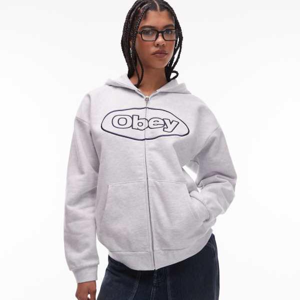 オベイ Obey Obey エクストラヘビーウェイト ジップスルーオーバルロゴパーカー（ライトグレー