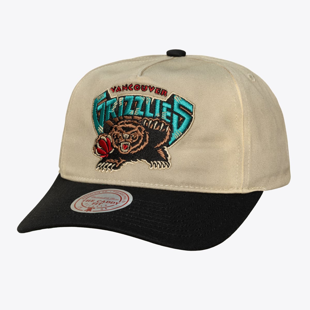Mitchell & Ness channels Hardwood Classics style into this Vancouver Grizzlies Retro Roots snapback. A structured high crown and slightly curved bill deliver a bold, throwback shape. Soft cotton construction and an adjustable snapback closure make it easy to wear and easy to fit. It's a vintage-inspired way to bring old-school team style into rotation.Structured high crown creates a bold, throwback silhouetteFeaturing a vintage construction inspired by the '90s, the Deadstock Fit is a must-have for any retro hat loverWipe clean with a damp clothSlightly curved bill keeps the classic look intactTwo-tone colorblocked construction adds contrast between the crown and billMaterial: 100% CottonSoft cotton build and an adjustable snapback closure deliver an easy, one-size fitImportedBrand: Mitchell & NessOfficially licensedSnapbackHigh CrownSlightly Curved BillContrast color undervisorStructured fitEmbroidered team patch with a clean, vintage-inspired look