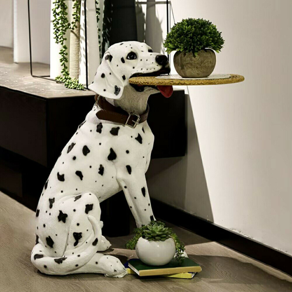 テーブル 置物 ダルメシアン 犬 サイドテーブル 高さ53cm インテリア テーブルダルメシアンサイズ高さ約53cm×横約40cm×幅約35cmトレイサイズ直径約26cm×厚み約7mm重量 約4kg素材 陶器、レジン、PUレザー・首輪付きです ※首のベルトはランダムとなっております。 ・トレイのくわえ方はトレイの出っ張りがある部分をダルメシアンの口の中に入れてくださいBIGサイズなダルメシアンのサイドテーブルが登場！樹脂でかたどられているダルメシアンは、犬の耳のたれ具合やぱっちりしたお目目とダルメシアン特有のドット模様などが本物そっくりです。目が合ったらハグしたくなる可愛さ。お手入れも簡単。置物やサイドテーブルという役割を飛び越え、家族のような存在となってくれることでしょう誰が見ても「かわいい！」と思ってしまうようなわんちゃんのサイドテーブルです。背中やお腹のフォルムのリアルさや、毛並みなど細部まで表現されています。 お部屋のアクセントや玄関に置いて小物を置くスペースなど様々な用途でお使いいただけます。 また、マスコット的な存在感があるのでサロンやショップで展示いただくのもおすすめです。サイズ感が大きめでかわいく、愛嬌のあるアニマルサイドテーブルを飾っていただくことでお部屋が賑やかになります！ダルメシアンの性格は、明るく陽気です。しかしその反面、警戒心が強く、飼い主以外の人や犬には、気を許さないところもあります。飼い主やともに暮らす家族には、とてもフレンドリーです。また、頑固な一面もあり、見知らぬ人には神経質な面を見せることも。玄関先に置けば、家族の帰りを待って遊びを催促しているような表情に見えてきます。ベッドサイドでは、眼鏡や携帯、目覚まし時計など預けてお休み前にほっこり気分に。レストランやショップ、美容院などに置けば皆から愛される「看板犬」になってくれることでしょうお部屋やリビングが一気に華やかになる犬のサイドテーブルです