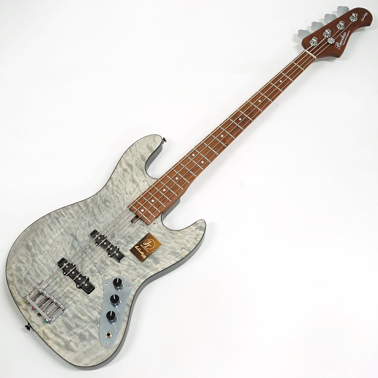 Headway、Seventy Sevenにて評価をいただいているJapan Tune-up series（通称『JTシリーズ』）が、ついにBacchusでも始動。 アジア工場で組み上げたギターを国内工房にて職人達が文字通り"チューンナップ"させることにより、より使いやすく、洗練したギターへと昇華させたコストパフォーマンスに優れたシリーズです。 上位機種ハンドメイドシリーズWOODLINEの演奏性を継承したコストパフォーマンスモデル。 ディンキーシェイプのボディはオーソドックスなJBスタイルながらシャープなシルエットで人気です。 キルトメイプルトップを採用した豪華なルックスにナトーボディ、ローステッドメイプルネック＆指板。 フィニッシュにはつや消しのサテン仕上げを採用しています。 上位機種Bacchus HANDMADE seriesのWOODLINEで搭載しているターボスイッチ。本モデルでももちろん搭載しています。 トーンノブをプルアップするとターボスイッチがオンとなります。 2つのシングルピックアップをシリーズ接続し、従来とは一味違う、太くハムバッキング・ピックアップのようなサウンドを作り出します。 このプライスdeこのルックスとスペック、さすがバッカスです。 ギグバック付属 【セール特価品】 特価価格販売品につき使用上問題のない外観上のわずかなチョイキズ,汚れ等ははご容赦下さいませ。 プレイヤビリティに関する初期不具合の場合は修理、もしくはご返金にて対応させて頂きます。 セール対象商品につき新品交換は出来ません。 店頭及び他のサイトでも販売しています。買い物かごに入れても売り切れの場合がございます。 ご了承の上、ご注文ください。 Specification Body Top :Quilted Maple Body :Nyato Neck :Roasted Maple Fingerboard :Roasted Maple Nut :PPS Bridge : JB bridge w/ brass saddle Machineheads :Opengear Fret :Nickel Silver Pickup :Original JB set Control :2Vol, 1Tone (Pull-up = turbo switch) Scale :864mm(34inch) Fingerboard Radius :305R Width at Nut :38.0mm Finish :Open-pore String :D&rsquo;addario XL-165 &nbsp; Bacchus Japan Tune-up Series 最大の特徴は、経験豊富な日本の職人の手によって行われる最終工程。ディバイザーが有する国内部署「WDG（Workshop Deviser Guitars）」にて、プレイアビリティに直結する部分を丁寧に仕上げます。 &nbsp;&nbsp;正確なトーンを生み出すフレットの仕上げ処理 上記の作業に加えて、弾きやすさに直結する弦高調整や指板の最終仕上げなどもチューンナップの項目として徹底的に行います。新品のギター、ベースは何かと弾きづらさを抱えることが多いですが、JTシリーズではご購入いただいたその日からプレイヤーの音楽ライフを支えられるようこだわりを持ち続けています。 &nbsp;高級感のあるキルトメイプルトップ ※キルトメイプルの杢目には個体差があります。 ボディトップには美しい杢目が目を引く、キルトメイプルを採用。つや消しタイプのマットな仕上げにより、キルトトップでありながらも非常に落ち着いた印象に。 本機の特徴として、全6色の豊かなカラーバリエーションをラインナップ。自分だけの個性あふれる一本を手にしていただけます。 &nbsp;WOODLINEゆずりのスリムボディ Handmadeシリーズで培った&ldquo;WOODLINE&rdquo;の持つ、ディンキーシェイプのボディを継承。一般的なJBタイプのエレキベースよりややスリムに設計されており、プレイアビリティに優れます。またボディ外周にはブラックのバインディングが施され、高級感のある引き締まったルックスを目指しました。 &nbsp;こだわりの真鍮ネックプレート 比重の高い真鍮（ブラス）製のオリジナルネックプレートを採用。従来品に比べて重量があり、密の詰まった中低音域にかけて広がるベース・トーンが特徴です。 &nbsp;WOODLINEシリーズ定番のターボスイッチ WOODLINEモデルではおなじみの「ターボスイッチ」を本機でも搭載。トーンノブをプルアップすることで、ターボスイッチがオンとなります。2つのシングルピックアップをシリーズ(直列)接続し、太くハムバッキング・ピックアップのようなサウンドを作り出します。(※ターボスイッチがオンの時音量はフロントVolノブで調整します。この時リアVolノブはバイパスされます) &nbsp;剛性を高めたローステッドメイプルネック Bacchusの新定番として好評のローステッドメイプルネックを本機でも採用。熱処理を加えることでネックとしての高い剛性を誇り反りに強くなるのみならず、立ち上がりの良い乾いたサウンドを得意とします。 Bacchus Japan Tune-up Series特設ページ &nbsp;