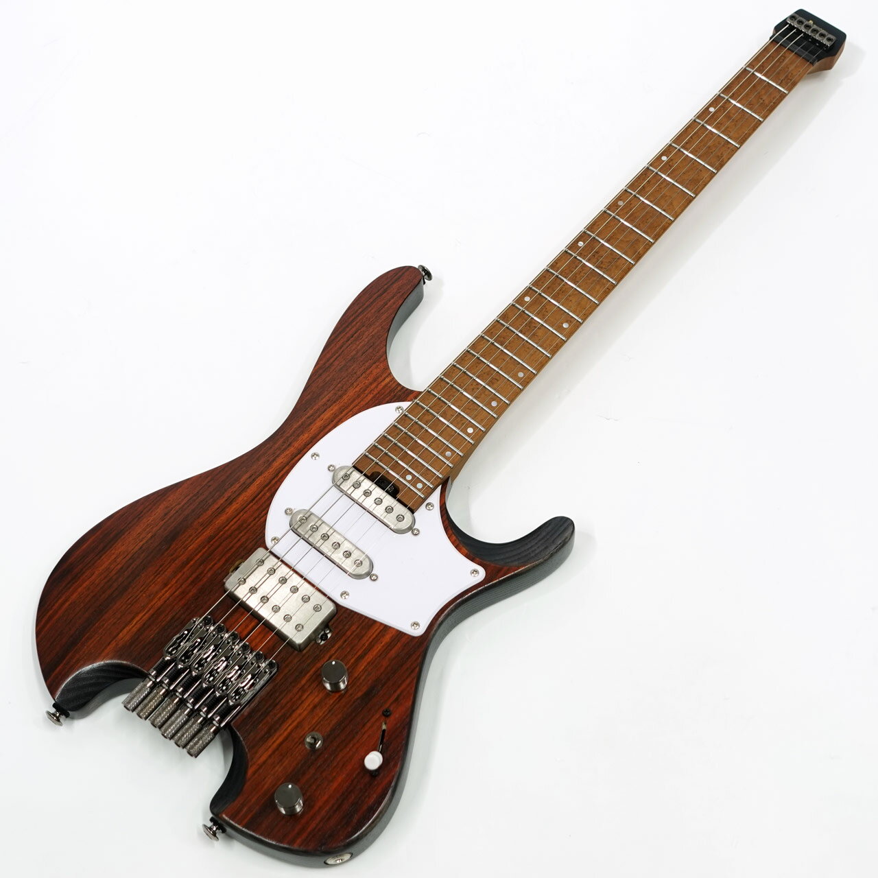 Ibanezから価格を抑えた待望のヘッドレスギターQuestシリーズ！ 既存のモデルをヘッドレス化したり、ヘッドレス用のパーツを集めて組み上げるのではなく 、&rdquo;まったく新しいギターをゼロから開発する&rdquo; という新たな探求（ Quest ）となりました。 様々なプレイヤーの演奏スタイルを研究し、ピックアップ、ブリッジ、ストリング・ロックといったパーツ類からボディの設計に至るまで、独自性とオリジナリティを追求しています。 ジャンルを問わずに自らの可能性を追求し続けるギタリストのあくなき探求心を満たす、そんなヘッドレス・ギターなのです。 ローズウッドトップにアッシュボディを採用したスポットモデル！ 人間工学に基づいたコンターやカットが施された非常にコンパクトかつ軽量なボディ。 ローステッドメイプルとブビンガの硬質な3Pネックにローステッドバーズアイメイプル指板を採用、ネックシェイプは様々な演奏スタイルに対応できる厚すぎず薄すぎない、馴染みやすいネックです。フレットにはジャンボステンレスフレットを採用し高い耐久性を持ちます。 Qシリーズの為に新開発されたCustom String Nut,Mono-Tune Bridgeは弦の種類を選ばず使用でき、イントネーションの調整幅も広くダウンチューニングにも対応。サドルを構成している部品数を極力少なくし、ギター本体の鳴りが生きるナチュラルなサウンドを実現しています。 &rdquo;Q&rdquo;のために開発されたシングルコイル・ピックアップ「R1」とハムバッカー・ピックアップ「Q58」を組み合わせた、S-S-H 配列。どちらも、エフェクター等でサウンドメイクしやすいよう、全帯域がバランスよく聴こえるように設計されています。低域は濁らずパワフルで、高域は明るくクリアでありながらもキンキンしない耳障りの良いサウンドです。また、低ノイズでデジタルエフェクター、アナログエフェクター両方ともに相性抜群です。シングルコイル、ハムバッカー両方のサウンドを楽しみたい方にお勧めです。 またAZシリーズで好評のミニスイッチによる切り替えによるシリーズ/パラレルモードと5Wayスイッチにより、シングルコイルの歯切れのよいサウンドからしっかり歪ませるハムバッカーサウンドまで幅広い音作りを可能にします。 こちらはSPOT生産モデルです。数量限定モデルではありませんが、レギュラーラインナップでは無いので、ひっそりと在庫が無くなれば生産完了&hellip;となる場合があります。気になる方はお早めにご検討下さい。 weight 2.575 kg ソフトケース付属 撮影環境、パソコン環境により色味は異なる場合もありますが、杢目は画像の商品でのお届けとなります。 他のサイトでも販売しています。買い物かごに入れても売り切れの場合がございますのであらかじめご了承下さいませ。 SPEC neck type Parallel Wizard C 3pc Roasted Maple/Bubinga neck top/back/body Rosewood top Ash body fretboard Roasted Birdseye Maple fretboard Mother of Pearl Step off-set dot inlay fret Jumbo Stainless Steel frets number of frets 24 bridge Ibanez Mono-Tune bridge string space 10.8mm neck pickup R1 (S) neck pickup Passive/Ceramic middle pickup R1 (S) middle pickup Passive/Ceramic bridge pickup Q58 (H) bridge pickup Passive/Ceramic factory tuning 1E,2B,3G,4D,5A,6E strings D'Addario EXL110 string gauge .010/.013/.017/.026/.036/.046 hardware color Cosmo black NECK DIMENSIONS Scale : 648mm/25.5" a : Width 42mm at NUT b : Width 57mm at 24F c : Thickness 21mm at 1F d : Thickness 22mm at 12F Radius : 305mmR &nbsp;