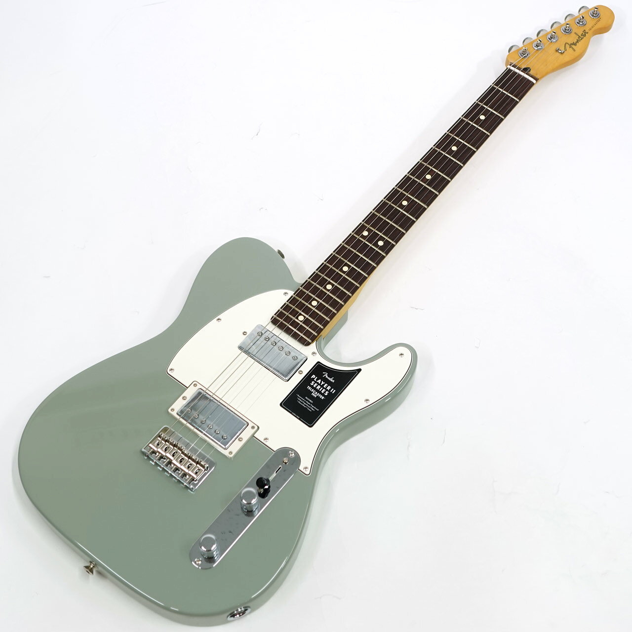 1950年に産声を上げたテレキャスターは今なおエレキギターの代表モデルとして各メーカーが参考にし続けるギターです。 Player II Telecaster HH は、時代を超越したフェンダーの魅力を放ちながらも、その中身は現代プレイヤー向けにデザインされています。Modern "C"シェイプのネックバックにはシルキーなサテンウレタンフィニッシュが施されており、丁寧にロールオフされた指板エッジと22本のミディアムジャンボフレットを採用した9.5インチラジアスのスラブローズウッド指板が、ネック全長にわたり快適なプレイアビリティを提供します。 クラシックなアルダーボディのPlayer II Telecaster HHは、伝統的なフェンダーフィニッシュ、またはフェンダーのカラーアーカイブから発掘され、本シリーズで初採用となる新フィニッシュなど、幅広いカラーの選択肢をご用意しています。Player Series Alnico IIハムバッカーからは明瞭度の高いハイエンド、力強いミッドレンジ、太くタイトなローエンドが得られます。3ウェイブレードスイッチにより、多彩なサウンド設計が可能です。6スチールブロックサドル式ブリッジと、ClassicGearチューニングマシンによりチューニングの安定性が確保され、無限のサウンドの可能性を追求できる柔軟性を備えています。 Player IIシリーズ製品は、フェンダーならではのルックス、トーン、フィーリングを備え、自分だけの個性的なサウンドを作り上げるのに最適な仕様でまとめ上げられています。 ギグバック付属 画像は以前の入荷時に撮影したものです。お届けの商品とは木目や色合いが異なる場合がございます。 店頭及び他のサイトでも販売しています。買い物かごに入れても売り切れの場合がございます。 ご了承の上、ご注文ください。 Body Material Alder Body Finish Gloss Polyester Neck Material Maple Neck Finish Satin Urethane Finish on Back of Neck with Gloss Urethane Headstock Face Neck Shape Modern "C" Scale Length 25.5" (648 mm) Fingerboard Material Slab Rosewood Fingerboard Radius 9.5" (241 mm) Number of Frets 22 Fret Size Medium Jumbo Nut Material Synthetic Bone Nut Width 1.650" (42 mm) Tuning Machine Fender ClassicGear Bridge Pickup Player Series Alnico 2 Humbucker Neck Pickup Player Series Alnico 2 Humbucker Controls&nbsp; Master Volume, Master Tone Bridge 6-Saddle String-Through-Body Tele with Block Steel Saddles &nbsp;