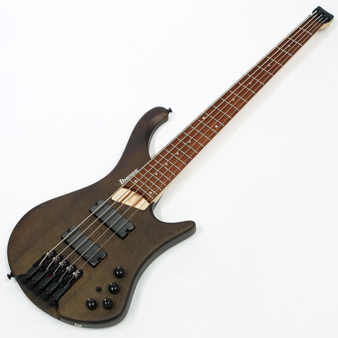 アイバニーズWorkshopオリジナルヘッドレス5弦ベースからより手に取りやすスペックで登場！ ヘッドレス・スタイル最大の利点である 持ち運びやすさ に加えて、 演奏のしやすさを兼ね備えたベース。 そしてなによりも、ベース ・サウンド &rdquo; に対する工夫。 従来、「鳴らない」とか「使い難い」と言われることが多かったヘッドレスを、Ibanez Bass Workshop が見つめなおし 、 全く新しいヘッドレス ・ベース &rdquo;EHB&rdquo; を作り上げました。 weight 3.290 kg エレクトリック ・ギター 用 ソフト ・ケース付属 撮影環境、パソコン環境により色味は異なる場合もありますが、杢目は画像の商品でのお届けとなります。 他のサイトでも販売しています。買い物かごに入れても売り切れの場合がございますのであらかじめご了承下さいませ。 - EHB エルゴノミック・ボディ・デザイン 立奏/座奏を問わずバランスよく収まるよう、人間工学に基づいて設計したボディ・デザインです。ホーンは立奏時にボディとネックとのバランスを取るとともに持ちやすい形状に、高音弦側のボディ・カーブは特に座奏時のフィット感とバランスを重視した設計です。ボディ表面の肘が当たる部分には傾斜をつけるコンター加工を入れています。また、体に触れる部分のボディ・エッジにはすべて滑らかなRをつけて処理しています。 - MR5HS mono-rail ブリッジ ブリッジエンド部を回すことでチューニングする専用ブリッジです。テフロン製ワッシャを採用し、回しやすさを獲得しています。サドルは左右に1.5mm可動可能で、弦間ピッチを可動範囲内で任意に設定可能です。プレイスタイルに合わせた細かなセッティングが行なえます。 - EHB専用のヘッドピース 裏側から6角レンチで回すことで、簡単に弦をセット&amp;リリース可能で、軽量且つ堅牢、さらにシンプルなデザインで仕上げた専用のヘッドピースです。 - Ibanez Custom Electronics 3-band EQ High/Mid/Low 3バンドのイコライジングが可能なアクティブEQです。パッシブ・モード時はHighノブがトーン・コントロールとして機能します。 ‐ Ibanez &alpha;1ピックアップ 豊かなロー&amp;ミドル・エンドに特性を持つと共に高いクラリティを備えた、モダン・サウンド志向のオリジナルピックアップを搭載しています。 - アクティブ / パッシブを瞬時に切替可能なEQ On/Off switch搭載 3バンドEQで幅広いサウンドメイクが可能なアクティブ・モードと直感的なトーン・コントロールで演奏するパッシブ・モードを切り替える、EQのオン/オフ・スイッチを装備しました。万一電池が切れた時でもパッシブ・モードに切り替えれば演奏可能です。 SPEC neck type EHB5 5pc Maple/Jatoba neck top/back/body Okoume body fretboard Jatoba fretboard White dot inlay fret Medium frets number of frets 24 bridge MR5HS bridge string space 18 mm neck pickup &alpha;1 neck pickup Passive bridge pickup &alpha;1 Bridge pickup Passive equaliser Ibanez Custom Electronics 3-band EQ w/ EQ bypass switch (passive tone control on treble pot) factory tuning 1G,2D,3A,4E,5B string gauge .045/.065/.085/.105/.130 hardware color Black NECK DIMENSIONS &nbsp; &nbsp; Scale : 864mm/34" &nbsp; &nbsp; a : Width 45mm at NUT &nbsp; &nbsp; b : Width 74mm at 24F &nbsp; &nbsp; c : Thickness 19.5mm at 1F &nbsp; &nbsp; d : Thickness 21.5mm at 12F &nbsp; &nbsp; Radius : 500mmR
