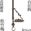 ◆製品仕様-Product Specifications- 寸法 全長 約150〜200cm（伸ばしたり縮めたり出来ます） 松竹梅部/約25.5×7.5（cm） 材質 銅 製作地 富山県高岡市 ◆商品説明-Description of item- 囲炉裏やかまどで鍋や釜、鉄瓶を吊るす際に必要な自在鉤（じざいかぎ）です。 てこの原理で長さを調節することが出来、煮炊きする鍋と火の距離を調節できますよ。 デザインはシンプルですっきりとした形状に縁起の松竹梅を飾り付けてあります。 銅器の質感がとても奥深い雰囲気ですよ。 ※箱の形状、色などは変更となる場合があります。 ※画像の色はブラウザや設定により、実物とは異なる場合があります。予めご了承下さい。この自在鉤は高岡にて製作しています。 自在鉤とは、囲炉裏で鉄鍋や鉄瓶などを吊るすために使われる道具です。昔話などには必ずと言っていいほど登場しますね。 てこの原理で自在鉤の鉤部分が伸び縮みできるようになっているので、火から鍋までの距離を上手く調節することができます。そこから「自在」と呼ばれるようになりました。 &nbsp; 「自在鉤　松竹梅」は高岡の鋳物の技術を用い、生型鋳造法という鋳造法で作られています。 生型鋳造法とは、まず木製又は金属製の上下枠に、製品と同じ形の原型を入れ、砂を入れて押し固めます。その後、上下の枠をはずし、原型を取り出すと砂で出来た鋳型が出来ます。 この鋳型に溶かした金属を流し込んで鋳物が出来上がります。 生型鋳造法は、シンプルな鋳造法で量産に最適な製法として高岡の鋳物を発展させた主力の技法なんですよ。