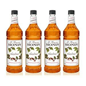 Monin - ヘーゼルナッツシロップ、キャラメル化したヘーゼルナッツのナッツのような味わい、天然フレーバー、モカ、ラテ、スムージー、シェイク、カクテルに最適、非遺伝子組み換え、グルテンフリー (1 リットル、4 パック) Monin - Hazelnut Syrup, Nutty Tas