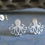 Υݥȥ󥰤ϡ󥰥СΥåɥ奨꡼᤭ޤꥫǼꡣ Poseidon's Booty Octopus post earrings brushed sterling silver stud jewelry. Handmade in the USA.