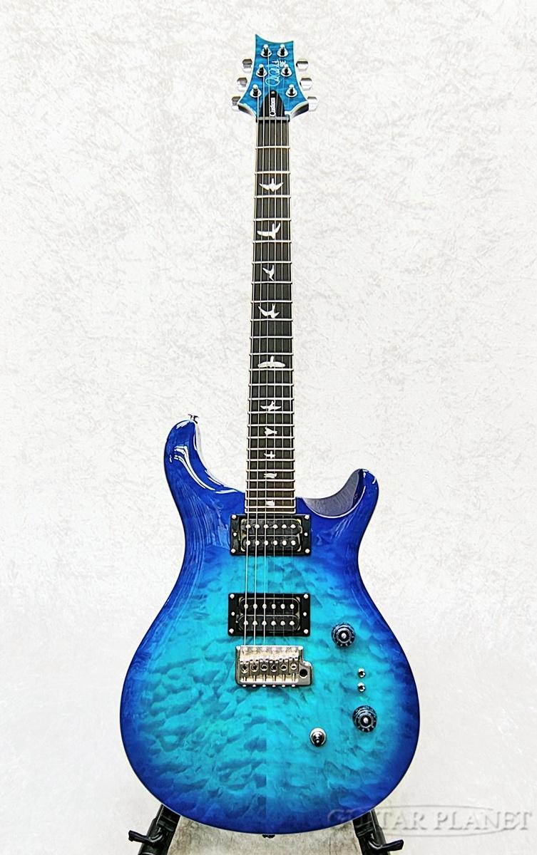 PRSギターズ・ジャパン正規輸入品 ニューカラーのレイク・ブルー SE Custom24-08が登場！！ SE Custom 24の35周年記念モデルで採用された仕様にグレードアップ。 キルトメイプル・トップ、ヘッドストックにもボディに合わせたキルト板を貼り合わせ、エボニー指板に変更した豪華な仕様。 ピックアップに35周年モデルにも採用されたTCI “S”を搭載。煌びやかなクリーンサウンドからロックなドライブサウンドまで幅広いジャンルに使用出来ます。 ミニスイッチ2基はリア、フロントの独立されたコイルタップの為、多彩なサウンドバリエーションが可能。 プレイヤビリティーに優れたSE Custom24-08初心者は勿論、幅広いジャンルをプレイするギタリストにオススメのモデルです。 キルトメイプルのうごめく杢目が最高に映える一本！！ 是非、このご機会にご検討くださいませ。 SPEC ［Body］ Top Wood/ Maple w/ Flame Maple Veneer Back Wood/ Mahogany Top Carve/ Shallow Violin Carve ［Neck］ Number of Frets/ 24 Scale Length/ 25" Neck Wood/ Maple Neck Shape/ Wide Thin Fretboard Wood/ Ebony Fretboard Inlay/ “Old School” Birds ［Hardware］ Bridge/ PRS Patented Tremolo, Molded Tuners/ PRS-Designed Tuners Hardware Type/ Nickel ［Electronics］ Treble Pickup/ TCI “S” Treble Bass Pickup/ TCI “S” Bass Controls/ Volume and Tone Control with 3-Way Toggle Pickup Switch and Two Mini-Toggle Coil-Tap Switches Strings/ PRS Classic, 9-42 Included Accessories/ PRS Gig Bag /_/_/_/♪出荷前調整のご要望承ります♪_/_/_/_/ ギタープラネットではご注文頂いた商品は 新品中古問わず検品・調整してから出荷致します。 弦高などの細かなセッティング等、お好みに 合わせての調整も可能ですので、お気兼ねなく お申し付けくださいませ。 /_/_/_/_/_/_/_/_/_/_/_/_/_/_/_/_/_/_/_/_/_/_ ※当商品は通信販売に限りご用意が可能でございます。実店舗での実機確認・試奏はお受け出来ませんので予めご了承ください。 ※掲載画像はサンプルになります。実際にお届けする商品とは色味や木目が異なる場合がございますのでご了承ください。 お問い合わせ:03-3259-0031　