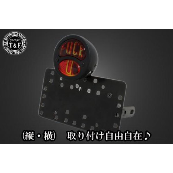 SN02325 ガレージT&F サイドナンバーキット&DUOテールランプ(FUCKU)ブラック+ステー グラストラッカースズキ グラストラッカー(全年式)【本体の仕様】 ・素材:スチール製。 ・カラー:ブラック仕上げ。 【テールランプ取り付けステーの仕様】 ・素材: スチール製。 ・カラー:ブラック仕上げ。 【配線の役割】 ・赤色:ブレーキランプ(+)。 ・青色:ポジションランプ(+)。 ・黒色:アース(-)。 ※製造ロットによってテールランプの配線の色、長さが変更されることがございますので予めご了承ください。 【製品の特徴】 ・通常のサイドナンバーKITでは縦固定か横固定のみですが、本製品は縦横どちらにも対応。あなたのバイクスタイルに合わせた自由なレイアウトが可能です。 ・取り付けステーの角度調整や前後スライド調整が出来る為、ナンバープレートの位置を思い通りにセッティング可能。細部まで理想のスタイルを実現します。 ・横向きの場合:7か所の取り付け位置を選択可能。 ・縦向きの場合:12か所の取り付け位置を選択可能。 ・車種専用のステー付きです。加工不要で取り付け可能。 ガレージT&F製フラットフェンダーKITと同時装着される場合はサイドナンバーオフセットKITを同時にお買い求め下さい。 【注意事項】 ・ガレージT&F製サイドナンバーKITは取り付け位置にかなり自由度がございます。しかしながらテールランプの種類によっては取り付け位置が制限される場合がございます。 ・ガレージT&F製フラットフェンダーKITと同時装着する場合も取り付け位置が制限される場合がございます。 ・車種によっては、別売のサイドナンバーオフセットKITが必要となる場合がありますのでご注意ください。 ・装着イメージは画像は全てドラッグスター400となります。取り付される車種によって多少イメージが異なる場合がございます。予めご了承下さい。 商品の改良や生産工程の変更により掲載されている仕様やデザインが予告なく変更される場合がございます。 SN02325楽天 JP店