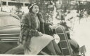 yzzr[ ͌^ fJ[ tF_[fR[gwoman in fur coat sitting on fender of early model car 1930s b w photo