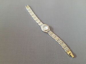 【送料無料】腕時計　モントルクアルツフェム?ミシェルデラビーエンメタルドレエアルジャンテアンボンイータmontre quartz femme ?michel delaby en metal dore et argente en bon etat