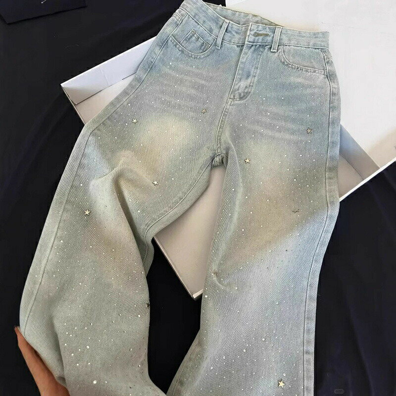 Wide-leg denim jeans for women. Light wash, high-waisted, relaxed fit, wide leg, long pants. Stylish, simple, flattering, leg-lengthening effect, star and rhinestone embellishments. Perfect for women in their 20s, 30s, 40s, and 50s. Elegant fashion.