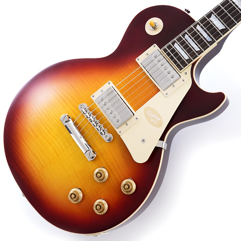 Epiphone Inspired by Gibson Custom Seriesギブソン カスタムショップとの緊密な連携により、エピフォン1959 Les Paul Standardは希少な1959年製モデルの忠実な再現に成功しました。マホガニー・ボディにフィギュアドメイプル・トップ（AAAグレードのフレイム・メイプル化粧板）の材構成を持ち、ロング・ネック・テノン仕様でジョイントされた'59ラウンデッド・ミディアムCプロファイル・ワンピースマホガニー・ネック、ギブソンスタイルのオープンブックR9ヘッドストックシェイプを採用しています。さらに、VOS（ヴィンテージ・オリジナル・シーン）フィニッシュ、Gibson Custombuckerハムバッキング・ピックアップ、Switchcraftセレクタースイッチと1/4出力ジャック、CTSポット、50年代風のワイヤリング、Malloryコンデンサー、オリジナル同様にベベル加工が施されていないピックガード、エピフォン・デラックスヴィンテージ・チューナー（キーストンボタン付き）等、充実した仕様を誇ります。外張りがブラウン色で内張りがピンク色のヴィンテージスタイルのハードケースが付属となります。※画像はサンプルです。製品の特性上、杢目、色合は個体ごとに異なります。BodyShape: Les PaulMaterial: MahoganyTop: Maple with AAA Flame Maple VeneerWeight Relief: N/ABinding: Single Ply， Top and FretboardNeckNeck: One Piece MahoganyProfile: 1959 Rounded Medium CNut width: 43mmFingerboard: LaurelScale length: 628.65mmNumber of frets: 22Nut: Graph TechInlay: Mother of Pearl TrapezoidHardwareBridge: ABR-1Tailpiece: Gibson Historic Reissue Stop BarTuners: Epiphone Deluxe with Keystone ButtonsPlating: NickelElectronicsNeck pickup: Gibson CustombuckerBridge pickup: Gibson CustombuckerControls: 2Volume， 2Tone; CTS Potentiometers， Mallory Capacitors， 50s WiringCaseCase: Hardshell with Brown Exterior PinkInterior and Inspired by Gibson Custom Graphicsイケベカテゴリ_ギター_エレキギター_Epiphone_レスポール_新品 JAN:4570156001740 登録日:2024/04/12 エレキギター エピフォン レスポール