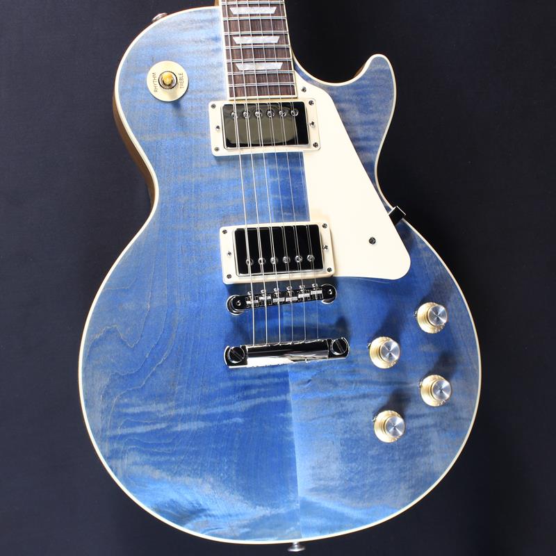 ■商品紹介Gibson Les Paul Standard 60s Custom Color SeriesCustom Color Seriesは、1960年代のギブソンのクラシカルなカスタムカラーと、近年のリミテッドランに採用された人気カラーからインスピレーションを得て誕生したモデルであり、ギブソンファンの皆様に、エキサイティングなカラーのレスポール・スタンダードをお届けします。ギブソンの定番モデル「レスポール・スタンダード」が入荷！コチラは、AAフィギュア・メイプルトップやスリムテーパーのネックシェイプを採用した60's仕様採用モデルです。ウエイトリリーフを施さないソリッドボディに、握りやすいスリムテーパーのネックをジョイント。キャビティはトラディショナルモデルと同様に、基盤を使わず配線されており、コンデンサーはオレンジドロップが使われております。サウンドの要であるピックアップには、60s Burstbuckerを搭載。芯のあるクリーントーンはもちろん、歪ませても骨太でバランスの良いドライブサウンドを奏でてくれます。ギブソン王道のロックサウンドを求めるギタリストには是非ともオススメの1本です。是非この機会をお見逃しなく！約4.46kgハードケース付属■仕様詳細BodyMaterial: MahoganyTop: AA Figured MapleWeight Relief: NoneBinding: Single-ply Top and FretboardNeckNeck: MahoganyProfile: Slim TaperNut width: 1.695 / 43.05mmFingerboard: Indian RosewoodScale length: 24.75 / 628.65mmNumber of frets: 22Nut: Graph TechInlay: Acrylic TrapezoidsHardwareBridge: ABR-1 Tune-O-MaticTailpiece: Aluminum Stop BarTuners:Grover Rotomatics w/ Kidney ButtonsPlating:NickelElectronicsNeck pickup: 60s BurstbuckerBridge pickup: 60s BurstbuckerControls:2 Volumes， 2 Tones & Toggle Switch (Hand-wired with Orange Drop Capacitors)検索キーワード：イケベカテゴリ_エレキギター_レスポールタイプ_Gibson_Les Paul Models_新品 SW_Gibson_新品 JAN:4570155996047 登録日:2025/12/20 エレキギター ギブソン レスポール