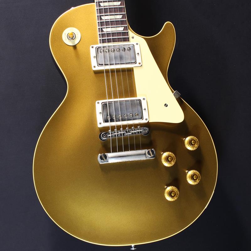 ■商品紹介Double Goldカラーの大人気1957 Les Paul Standard Reissue Dark Backが入荷！長きに亘り培われた高い製作技術と飽くなき探究心、厳選されたマテリアルにより至高のエレキギター・ベースを製作するために1993年に立ち上げられたGibson Custom Shop。現在もなお昔ながらのハンドクラフト製法と、徹底的に追求したヴィンテージの知識から製作されたカスタムショップ・ラインナップは、他所の追従を許さないほどの見事な作りとなり、プレイヤーの内に秘めるインスピレーションを際限なく沸き立たせてくれる最高の愛機となるでしょう。1952年、Les Paul Model誕生以来、58年中期までラインナップされたGold Topカラー。スタンダードシリーズにおいて、58年以降になるとチェリーサンバーストを筆頭に様々なバーストが誕生致しましたが、俄然人気を誇るカラーで御座います。黄色味なインレイやエイジドされたニッケルパーツ、バンブルビー搭載などヴィンテージへの拘りが体現されたまさに至高の一本。幾度と無くレシピがマイナーチェンジされているGibsonのGoldカラーですが、今回はまさにGold Top好きにはたまらないDouble Goldカラーでございます！！また当モデルはダークバック仕様となっており、通常の1957 Les Paul Standard Reissue Gold Topと比べて落ち着いた印象を与えておりGoldとの対比を楽しめます。昨今のGibson Cusotom ShopモデルというとMurphy Labによるエイジング加工が定番となっておりますが当モデルはVOS塗装となっておりウェザーチェックなどが入っていない艶を抑えたグロス仕上げとなっております。金属パーツはサビやくすみを再現しているためウェザーチェックやエイジング加工がお好みでない方には見逃せないオススメの一本となります。ネックシェイプは現行のカスタムショップの中でも最たる太さを誇る「50s Rounded Medium C」を採用しており、ビンテージ志向の方にはオススメの極太ネックとなっております。ピックアップは近年の定番モデルとなっているCustombucker Alnico IIIを継続して採用。キレのよいバイト感と個体がもたらす豊かなトーンバランスは本機でしか味わえない絶品サウンドをご体感頂けることでしょう。新たに搭載されたバンブルビータイプのペーパーオイルコンデンサーやヴィンテージカーブを追及した500KのCTSポットを装備。通常仕様の500kΩポットに比べてボリュームを絞っても極端に高域が削られず、手元の操作でクリーンサウンドからドライブサウンドまでを自在に操ることができます。10〜6のメモリまでは歪みが維持され、6〜1にかけて滑らかにダウンしていくので、ボリュームコントロールの長さによって表情豊かなプレイを可能にしています。細部にまでヴィンテージに拘りを持ったGibsonが送る最新スペックは、あなたのギターライフをより豊かにしてくれること間違い御座いません！！是非お手にとってご体感ください！！約3.92kgカスタムショップブラウンハードケース、認定書、他付属■仕様詳細BodyBody Top Material: 2-Piece Plain Maple， Hide Glue FitBody Back Material: Lightweight MahoganyBinding Style: 1-Ply RoyaliteWeight Relief: NoneFinish: Nitrocellulose VOS (Vintage Patina)NeckNeck Material: Solid MahoganyNeck Profile: 50s Rounded Medium CScale Length: 24.75 / 62.865cmFingerboard Material: Indian Rosewood， Hide Glue FitFingerboard Radius: 12 / 304.8mmNumber of Frets: 22Frets: Historic Gibson Narrow/TallNut Material: NylonNut Width: 1.687 / 42.85mmInlays: Aged Cellulose Nitrate TrapezoidHardwareFinish: NickelBridge: No-Wire ABR-1Tailpiece: Lightweight Aluminum Stop BarTuners: Kluson Single Line， Single RingPick Guard: Laminated Cellulose Acetate ButyrateTruss Rod Cover: Authentic Stepped 2-PlyElectronicsNeck Pickup: Custombucker Alnico III (Unpotted)Bridge Pickup: Custombucker Alnico III (Unpotted)Controls: CTS 500K Audio Taper Potentiometers， Paper-in-Oil Capacitors検索キーワード：イケベカテゴリ_エレキギター_レスポールタイプ_Gibson_Custom Shop_新品 SW_Gibson_新品 JAN:4580228786055 登録日:2026/02/01 エレキギター ギブソン カスタムショップ