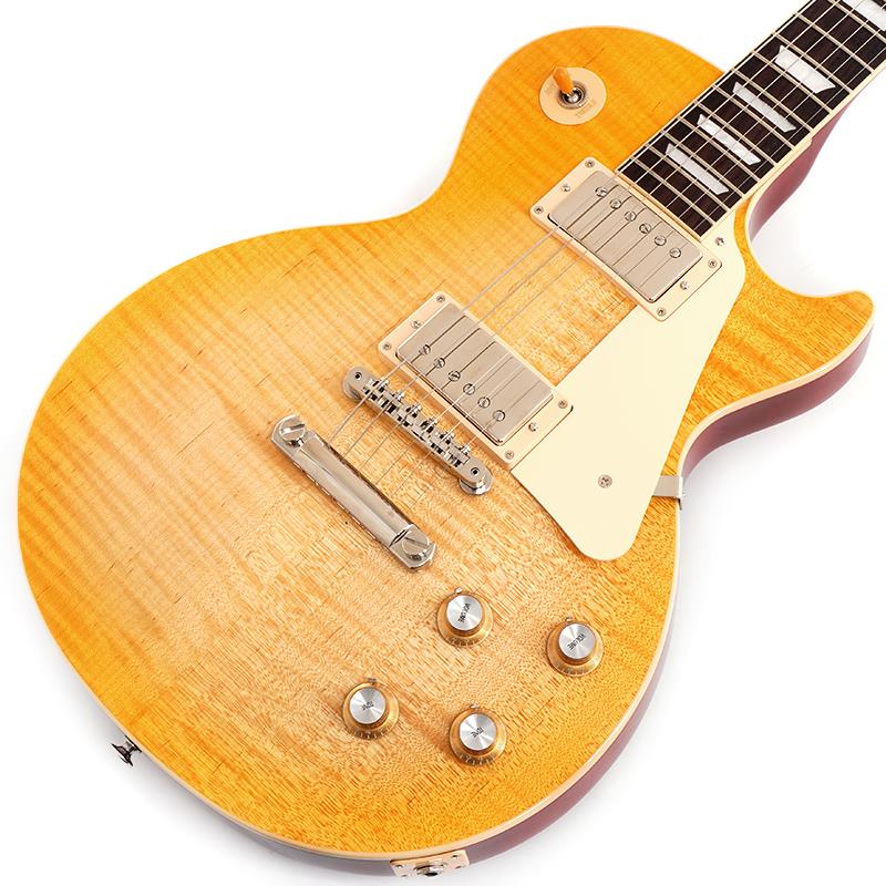 ■商品紹介USディーラー限定カラーの「Les Paul Standard 60s AAA Flame Top」が入荷！！淡いレモンバーストカラーがAAAグレードの美しい杢目を引き立てる1本。ウエイトリリーフを施さないソリッドボディに、握りやすいスリムテーパーのネックを採用した60's仕様モデルです。キャビティはトラディショナルモデルと同様に、基盤を使わず配線されており、コンデンサーはオレンジドロップが使われております。サウンドの要であるピックアップには、バーストバッカー61R&バーストバッカー61Tを搭載。芯のあるクリーントーンはもちろん、歪ませても骨太でバランスの良いドライブサウンドを奏でてくれます。日本国内レギュラーモデルには無いレアモデルにて是非この機会をお見逃しなく！S/N 226330173Weight≒4.69kg■仕様詳細BodyMaterial: MahoganyTop: AAA Figured MapleNeckNeck: MahoganyProfile: Slim TaperNut width: 1.695 / 43.05mmFingerboard: RosewoodScale length: 24.75 / 628.65mmNumber of frets: 22Inlay: Acrylic TrapezoidsElectronicsNeck pickup: Burstbucker 61RBridge pickup: Burstbucker 61TControls: 2 Volumes， 2 Tones & Toggle Switch (Hand-wired with Orange Drop Capacitors)ハードケース付属検索キーワード：イケベカテゴリ_エレキギター_レスポールタイプ_Gibson_Les Paul Models_新品 SW_Gibson_新品 JAN:4570155998652 登録日:2026/03/21 エレキギター ギブソン レスポール