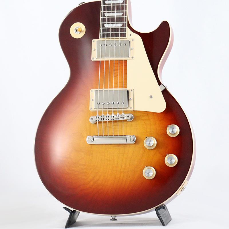 ■商品紹介Gibson Nashville Summit 2025 現地選定品！Gibson Les Paul Standard '60sGibsonの定番モデル「Les Paul Standard '60s」が入荷！コチラは、AAフィギュア・メイプルトップやスリムテーパーのネックシェイプを採用した60's仕様採用モデルです。ウエイトリリーフを施さないソリッドボディに、握りやすいスリムテーパーのネックをジョイント。キャビティはトラディショナルモデルと同様に、基盤を使わず配線されており、コンデンサーはオレンジドロップが使われております。サウンドの要であるピックアップには、バーストバッカー61R&バーストバッカー61Tを搭載。芯のあるクリーントーンはもちろん、歪ませても骨太でバランスの良いドライブサウンドを奏でてくれます。ギブソン王道のロックサウンドを求めるギタリストには是非ともオススメの1本です。是非この機会をお見逃しなく！■仕様詳細Weight≒4.43kgBodyMaterial: MahoganyTop: AA Figured MapleWeight Relief: NoneNeckNeck: MahoganyProfile: Slim TaperNut width: 1.695 / 43.05mmFingerboard: RosewoodScale length: 24.75 / 628.65mmNumber of frets: 22Nut: Graph TechInlay: Acrylic TrapezoidsHardwareBridge: ABR-1 Tune-O-MaticKnobs: Gold Top Hats with Silver Reflector & PointersTuners: Grover Rotomatics w/ Kidney ButtonsPlating: NickelElectronicsNeck pickup: Burstbucker 61RBridge pickup: Burstbucker 61TControls: 2 Volumes， 2 Tones & Toggle Switch (Hand-wired with Orange Drop Capacitors)ハードケース付属検索キーワード：イケベカテゴリ_エレキギター_レスポールタイプ_Gibson_Custom Shop_新品 SW_Gibson_新品 JAN:4580228786970 登録日:2025/12/25 エレキギター ギブソン カスタムショップ