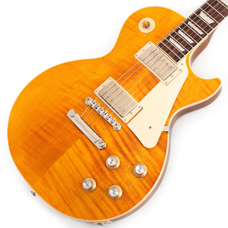 楽器種別：新品Gibson/Les Paul Models 商品一覧＞＞Gibson/新品 商品一覧＞＞エレキギター【220，000円〜410，000円】 商品一覧＞＞レスポールタイプ/Gibson 商品一覧＞＞当店のギターは、出荷前に専門スタッフが検品・調整しているので安心です！Gibson Les Paul Standard 60s Figured Top (Honey Amber) 【S/N 206860286】商品説明Gibson Les Paul Standard Custom Color SeriesCustom Color Seriesは、1960年代のギブソンのクラシカルなカスタムカラーと、近年のリミテッドランに採用された人気カラーからインスピレーションを得て誕生したモデルであり、ギブソンファンの皆様に、エキサイティングなカラーのレスポール・スタンダードをお届けします。AAフィギュア・メイプルトップやスリムテーパーのネックシェイプを採用した60's仕様採用モデルです。ウエイトリリーフを施さないソリッドボディに、握りやすいスリムテーパーのネックをジョイント。キャビティはトラディショナルモデルと同様に、基盤を使わず配線されており、コンデンサーはオレンジドロップが使われております。サウンドの要であるピックアップには、60s Burstbuckerを搭載。芯のあるクリーントーンはもちろん、歪ませても骨太でバランスの良いドライブサウンドを奏でてくれます。ギブソン王道のロックサウンドを求めるギタリストには是非ともオススメの1本です。S/N 206860286Weight≒4.20kg商品詳細BodyMaterial: MahoganyTop: AA Figured MapleWeight Relief: NoneBinding: Single-ply Top and FretboardNeckNeck: MahoganyProfile: Slim TaperNut width: 1.695 / 43.05mmFingerboard: Indian RosewoodScale length: 24.75 / 628.65mmNumber of frets: 22Nut: Graph TechInlay: Acrylic TrapezoidsHardwareBridge: ABR-1 Tune-O-MaticTailpiece: Aluminum Stop BarTuners:Grover Rotomatics w/ Kidney ButtonsPlating:NickelElectronicsNeck pickup: 60s BurstbuckerBridge pickup: 60s BurstbuckerControls:2 Volumes， 2 Tones & Toggle Switch (Hand-wired with Orange Drop Capacitors)ハードケース付属イケベカテゴリ_エレキギター_レスポールタイプ_Gibson_Les Paul Models_新品 SW_Gibson_新品 JAN:4570155996030 登録日:2026/05/13 エレキギター ギブソン レスポール