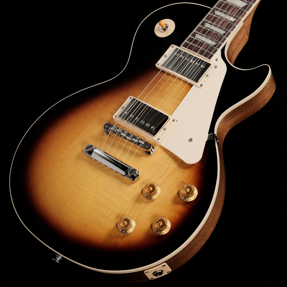 ■50s Les Paul Standardがパワーアップして登場！ ダントツ人気の50s Les Paul Standardが待望の再入荷！Gibson 50s Les Paul Standard 、メイプルトップにウエイトリリーフを廃したマホガニーボディ、50年代の丸みを帯びたネックを採用した往年のレスポールスタンダードを求めるプレイヤーに最適な一本です。ピックアップには定評のあるBurstbucker 1(Neck)/Burstbucker 2(Bridge)を搭載し、左手の細かなニュアンスやピッキングの強弱、繊細なボリュームコントロールといった演奏表現を余さず出力します。近年のギブソンに見られる基盤でなく、ハンドワイヤードの電装にはオレンジドロップキャパシターを搭載！キーストーンペグ、ワイヤーなしのABRブリッジにアルミニウム製ブリッジ・テイルピースなど、ヴィンテージを意識した拘りが満載でございます。使い込むほどに手に馴染み、より一層オールド感が引き立つ至極の一本となるでしょう！※ご購入後、同梱されるユーザー登録カードに必要事項をご記入の上、ギブソン・ジャパンへご郵送ください。ユーザー登録したご本人様に限り、メーカー規定の故障に対して無期限での保証が提供されます。■S/N:203140057■重量:4.11kg■JANコード:4580228786949■付属品:ハードケース、Gibsonユーザー登録カード 製品仕様 Body MaterialMahoganyBody TopMapleWeightReliefNoneFinishGloss Nitrocellulose LacquerNeck MaterialMahoganyNeck ProfileVintage 50sScale Length24.75"Fingerboard MaterialRosewoodFingerboard Radius12"Number Of Frets22FretsMedium JumboNut MaterialGraph TechNut Width1.695"End of Board Width2.26"InlaysAcrylic TrapezoidsHardware FinishNickelBridgeABRTailpieceAluminum Stop BarPickguardCreamControl KnobsAmber Top Hats w/ PointersSwitch TipAmberSwitchwasherCreamJack Plate CoverCreamNeck PickupBurstbucker 1Bridge PickupBurstbucker 2Controls2 Volumes, 2 Tones & Toggle Switch &#40;Hand-wired with Orange Drop Capacitors&#41;Strings.010, .013, .017, .026, .036, .046CaseHard Shell Case