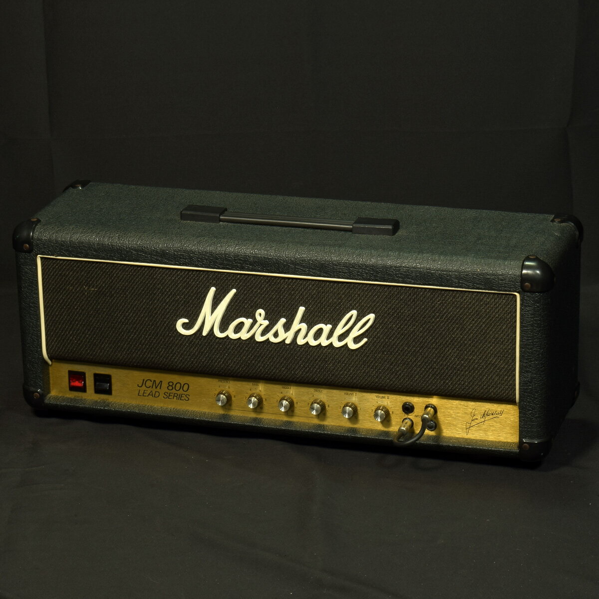 1988年製 Marshall「1987 JCM800 50w 」 ヘッドアンプです。80年代のロックシーンを支えた、マーシャル "JCM800" シリーズの50W出力、4インプットの Model "1987" Lead です。4インプットですので、マスター付きモデルと比較するとピュアなオーバードライブ・トーンを持ち、パワー管本来のオーバードライブサンドが楽しめます。4インプットならではのチャンネルリンクすることにより、通常のEQコントロールとは違う音色や歪み具合の調整も多彩に選択する事が可能になります。現状ガリなどなく使用に問題ございません。インプットジャックが交換されています。アンプ下部にトーレックス剥がれあり商品ランク:B+ （良品）保証　：　3ヶ月付属品　： 本体のみ　 シリアル　：　W25702