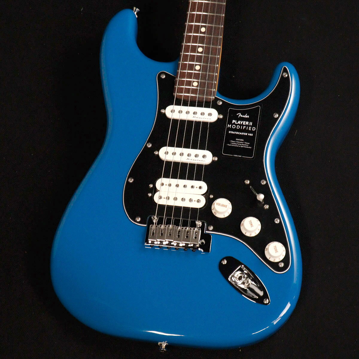 大人気のPlayer IIに様々なアップグレードを施した『Player II Modified』登場！ 現代のギタリストやベーシストのための主要なアップグレードが施されたPlayer II Modifiedは、あなたのパフォーマンスを次のレベルに引き上げてくれる多用途な製品をラインアップしています。 Player II Modified Stratocaster HSSは、モダンプレイヤーを念頭に置いて設計されたクラシカルなギターです。 Modern “C”ネックシェイプ、シルキーなサテンウレタンフィニッシュを施したネックバック、9.5インチラジアスのスラブローズウッドまたは1ピースメイプル指板、滑らかにロールオフ処理された指板エッジ、22本のミディアムジャンボフレットなど、ネックに注がれたすべてのディテールが、高速で流れるようなプレイアビリティをサポートします。 アルダーボディはフェンダーらしいパンチのあるトーンが特徴で、様々な新しいカラーフィニッシュが用意されています。 Player IIハムバッカーは明瞭度の高いパワフルなサウンドを提供し、Player II Noiselessピックアップは、不要なノイズを抑制しながら、クラシックなストラトの煌びやかなトーンを奏でます。 トーン2ノブに備えられたプッシュ／プルスイッチ機能は、ハムバッカーをコイルスプリットし、シングルコイルとして使用することも可能です。 2点支持トレモロ、ショートポストロッキングチューナー、TUSQナット、モダンストリングツリーにより、驚異的なチューニングの安定性を実現します。 面取りされたトレモロブロックの広い可変幅により、さらに表現力豊かで音楽的なビブラートを得ることが可能です。 主な仕様 Body Material : Alder Body Finish : Gloss Polyester Neck : Maple, Modern “C” Neck Finish : Satin Urethane Fingerboard : Rosewood, 9.5” (241 mm) Frets : 22, Medium Jumbo Position Inlays : White Dot (Rosewood) Nut (Material/Width) : TUSQ, 1.650” (42 mm) Tuning Machines : Deluxe Cast/Sealed Locking (all short posts) Scale Length : 25.5” (64.77 cm) Bridge : 2-Point Synchronized Tremolo with Block Saddles and Chamfered Tremolo Block Pickguard : 3-Ply Black/White/Black Pickups : Player II Modified Humbucker (Bridge), Player II Noiseless Strat (Middle), Player II Noiseless Strat (Neck) Pickup Switching : 5-Position Blade : Position 1. Bridge Pickup, Position 2. Bridge and Middle Pickup, Position 3. Middle Pickup, Position 4. Middle and Neck Pickup, Position 5. Neck Pickup Auxiliary Switching : Push/Pull Pot On Tone 2 For Coil Split on Humbucking Pickup Controls : Master Volume with Treble-Bleed, Tone 1. (Neck/Middle Pickups), Tone 2. (Bridge Pickup) Control Knobs : Parchment Plastic Hardware Finish : Nickel/Chrome Strings : Fender USA 250L Nickel Plated Steel (.009-.042 Gauges), PN 0730250403 Case/Gig Bag : Included : Deluxe Gig Bag ■ シリアル : MX24103911 ■ 重量 : 3.62kg ■JAN : 0885978398515 付属品：デラックスギグバッグ、トレモロアーム、調整用レンチ、メーカー保証書 複数のサイトに掲載しておりますため、他のサイトにて既にご販売済みである場合もございます。 売却に伴う商品情報の削除は迅速を心掛けておりますが、ご注文後に万一売り切れとなっておりました際は誠に申し訳ございませんがご容赦くださいませ。
