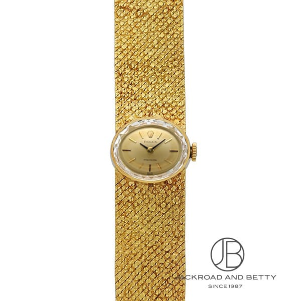[商品ID：5649103] &nbsp;PRODUCT&nbsp;&nbsp;-&nbsp;商品名&nbsp;- BRANDブランド ロレックスROLEX MODELモデル プレシジョン &nbsp;DETAILS&nbsp;&nbsp;-&nbsp;商品詳細&nbsp;- ロレックス プレシジョンは、1960年代に製造された手巻き式の時計で、オーバルケースと18金無垢製のブレスレットが特徴的な、非常にエレガントなデザインのモデルです。 この時代のロレックスは、精度とともに美しいデザインにも優れており、時計としての実用性と装飾性の両立が見事です。 カットガラスを使用した横型のオーバルケースが非常に魅力的で、光の反射により華やかな印象を与えます。 このデザインは非常にユニークで、現代の時計とは一線を画すクラシックな美しさを感じさせます。 ケースとブレスレットは18金無垢製で、重厚感とともに上品な高級感を漂わせています。 しっかりとした重量感があり、腕に着けた際にその存在感を強く感じられます。 凝った装飾が施されたブレスレット：約16mm幅のブレスレットは、細部にわたり精緻な装飾が施されており、視覚的にも非常に美しい仕上がりとなっています。 ロレックスの精密な手巻き式ムーブメントを搭載しており、精度においても信頼できます。手巻き時計の魅力を感じられるモデルです。 現状では、手首16cm〜16.5cmの方に適したサイズとなっていますが、サイズ調整が可能です。 全体的に目立つ傷はなく、非常に綺麗な状態です。ヴィンテージ時計ならではの味わいがありながらも、長年の使用感を感じさせない上品さがあります。 ※サイズ調整をご希望の場合は、別途有料にて承っております（納期：約1ヶ月）。詳しくはスタッフまでお問い合わせください。 メンテナンス済 &nbsp;SPEC&nbsp;&nbsp;-&nbsp;商品スペック&nbsp;- 保証 ： 当店オリジナル保証1年 状態 ： ヴィンテージ サイズ ： レディース ケース径 ： 15 × 18 mm ムーブメント / キャリバー ： 手巻き 製造年代 ： 1960 防水性能 ： 非防水 風防 ： ミネラルガラス風防 付属品 ： メーカー純正BOX無し国際保証書無し ケース素材 ： (ゴールド：18K)イエローゴールド ベルト素材 ： (ゴールド：18K)イエローゴールド ベルトタイプ / サイズ ： ブレス / 16.5 文字盤カラー ： シャンパンゴールド 文字盤タイプ ： なし