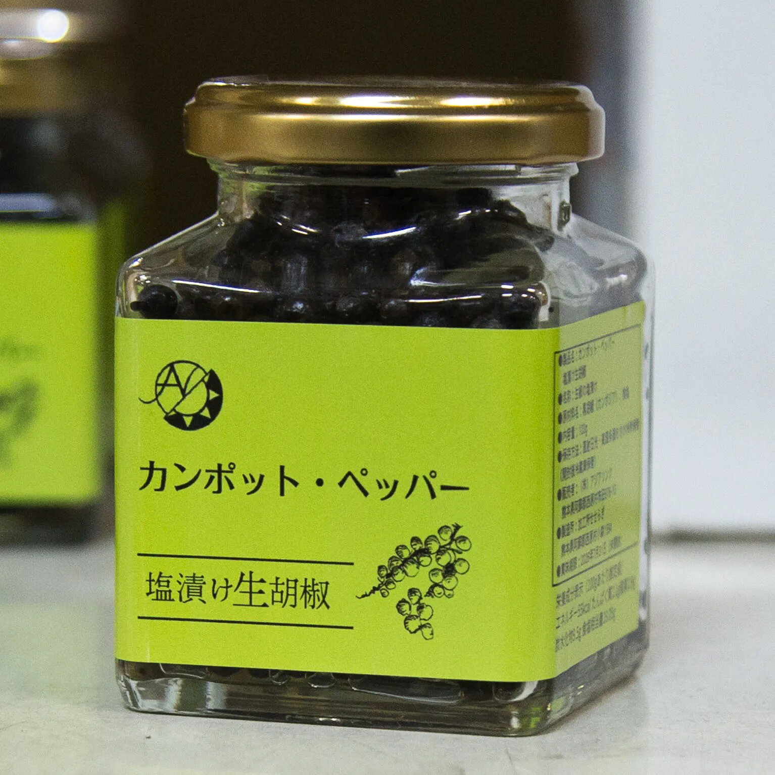 特徴カンボジアのカンポット・ペッパーを生のまま天然海塩で漬け込んだ塩漬け黒胡椒です。口の中で、塩の旨味とともに胡椒がプチッとはじけて、爽やかでフルーティーな香りが鼻を抜け広がるのが特徴です。ただ辛いだけでなく、カンポットペッパー特有の芳醇な味わいと、香り、柔らかくジューシーな後味を楽しむことができます。 カンポットペッパー(Kampot Pepper)とは、フルーティーで華やかな香りと、マイルドながら奥深い辛味が特徴の胡椒です。カンボジア南部のカンポット州とケップ特別市で、化学肥料や農薬を一切使わずに、完全有機で栽培され、1粒1粒手作業で選別された、大きな実のみがカンポット・ペッパーとして認められます。100年以上前からの伝統農法を、カンポットペッパー協会がガイドライン化し、その有機栽培ガイドラインに沿って栽培した農園のみ、『カンポットペッパー』ブランドが使用でき、品質を厳しく管理されています。カンポットペッパーには赤、白、黒の3種類の胡椒がありますが、黒胡椒はいわゆる"コショウ"の定番で、種と皮の両方の味と香りが絡まって、複雑な味わいを楽しめ、胡椒独特の香りが強いものになります。乾燥させない生の胡椒を収穫後すぐに塩漬けにしているため、柔らかく、ミルを使わずそのまま使用できます。マイルドながら奥深い辛味と塩味で、肉料理、卵料理、お野菜、チーズ、オードブルの他、アイスクリームなどの菓子や、ご飯のトッピングなどといった和食とも高相性です。粒のまま、または刻んで、和洋中問わず様々な料理に活用していただけるアイテムです。アジアリンクはベトナム、カンボジアの現地農園と直接連携し、厳選したオーガニック商品の輸入から販売まで行っている会社です。 2024年に熊本県阿蘇郡で創業され、食がもたらす「美味しさ」と「心をつなぐ力」を大切にしながら、生産者の想いが伝わる商品と体験を届けていきたいという考えの元、現地農園の栽培環境や雇用状況の確認、日本の消費者の声や販売状況を生産者に伝え、相互理解を深める取り組みを行っています。使用上の注意開封後は密封して冷蔵庫に保管し、速やかにご使用ください主な用途製菓、製パン全般でご使用いただけます。