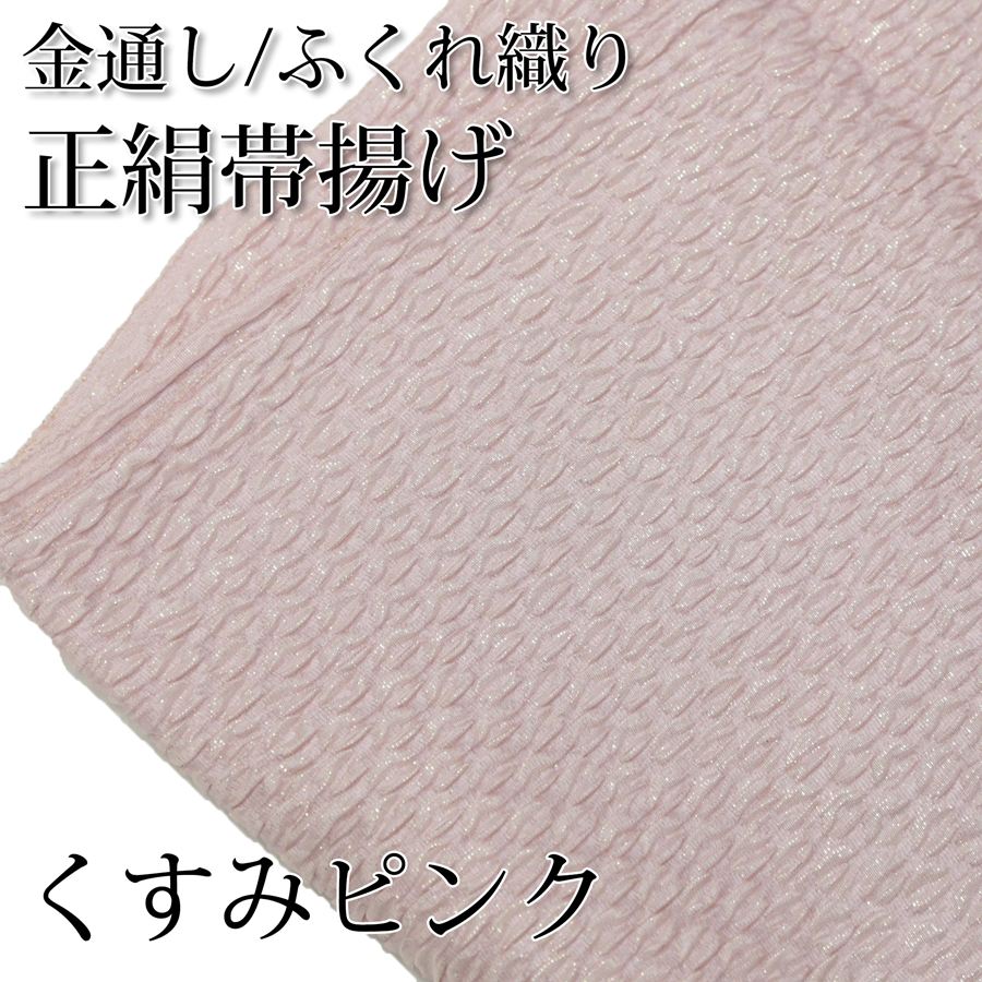 金糸が織り込まれたふくれ織の正絹帯揚げです。織物の郷、京都丹後地方で織り上げられた上質な国産帯揚げです。くすんだ薄いピンクの地色に金通しの糸が織り込まれています。光の当たり方や角度によって上品にキラキラと煌めいています。 成人式や結婚式の振袖、晴れ着などに最適です。 ＜サイズ＞ 約20×170cm ＜品質＞ 絹100% ※サイズは製造時期や入荷時期によって実際のサイズと多少異なる場合がございますが、帯揚げとしての使用用途としては差し支えない誤差です。 ※お客様のモニター環境などにより写真と実物の色目に若干の差異が生じる場合あります。予めご了承ください。