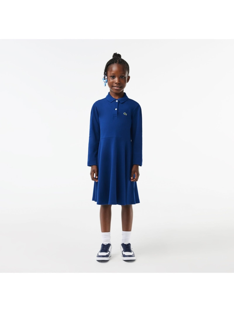 LACOSTE（ラコステ）GIRLS鹿の子地ポロドレスラコステブランドの定番である鹿の子素材のポロシャツを、キュートなガールズドレスへとアレンジ。トップスをベーシックなディテールで仕立てつつ、スカート部分はフェミニンなフレアシルエットで。スポーツカジュアルと女の子らしいエレガンスを兼ね備えた、ラコステならではの1枚です。RegularFit型番：EJ9751-10-F9F-Y GB6222【採寸】サイズ身丈身幅袖丈肩幅4A(104cm)57cm33.5cm33cm27.2cm6A(116cm)62cm35.5cm39.5cm29cm8A(128cm)68cm36.5cm44cm30cm10A(140cm)74.5cm39.5cm49cm32.5cm商品のサイズについて【商品詳細】トルコ素材：本体：綿 94% ポリウレタン 6% / リブ部分：綿 100%サイズ：10A(140cm)、4A(104cm)、6A(116cm)、8A(128cm)※画面上と実物では多少色具合が異なって見える場合もございます。ご了承ください。商品のカラーについて 【予約商品について】 ※「先行予約販売中」「予約販売中」をご注文の際は予約商品についてをご確認ください。■重要なお知らせ※ 当店では、ギフト配送サービス及びラッピングサービスを行っておりません。ご注文者様とお届け先が違う場合でも、タグ（値札）付「納品書 兼 返品連絡票」同梱の状態でお送り致しますのでご了承ください。 ラッピング・ギフト配送について※ 2点以上ご購入の場合、全ての商品が揃い次第一括でのお届けとなります。お届け予定日の異なる商品をお買い上げの場合はご注意下さい。お急ぎの商品がございましたら分けてご購入いただきますようお願い致します。発送について ※ 買い物カートに入れるだけでは在庫確保されませんのでお早めに購入手続きをしてください。当店では在庫を複数サイトで共有しているため、同時にご注文があった場合、売切れとなってしまう事がございます。お手数ですが、ご注文後に当店からお送りする「ご注文内容の確認メール」をご確認ください。ご注文の確定について ※ Rakuten Fashionの商品ページに記載しているメーカー希望小売価格は、楽天市場「商品価格ナビ」に登録されている価格に準じています。 商品の価格についてLACOSTELACOSTEのシャツワンピースワンピース・ドレスご注文・お届けについて発送ガイドラッピンググッズ3,980円以上送料無料ご利用ガイド