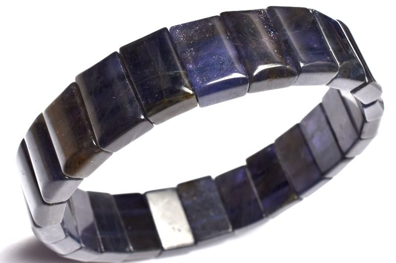 材質アイオライトサンストーン 8.5x13-14mm 産地：インドサイズ約8.5x13-14mm腕周り約17.5cm(伸縮性あり)重さ約33g特徴・意味高品質で透過性があり、アイオライト特有の多色性のカラーを堪能していただける逸品です。アベンチュレッセンスが共生しており、キラキラと輝きを放っています。多色性特有のブラウンカラーからパープルブルーカラーへの変化は夕暮れから夜にかけての空を閉じ込めたような幻想的な美しさがあります。アイオライトサンストーンは、アイオライトとサンストーンの両方の鉱物組成とエネルギー特性を持っていると、メロディ女史とシモンズ氏の著書の両方に記されています。アイオライト・サンストーンの素晴らしいエネルギーはシモンズ著「TheBookofStones」は以下のように記されています。「アイオライト・サンストーンはあなたが期待するとおり、アイオライトとサンストーンの特性を併せ持っています。それに加えて2つのマテリアルを合わせたシナジー効果によりいくつかの完全に新しいエネルギー効果を生み出します。アイオライトはインナービジョンの石で、サードアイを刺激し、サイキック能力や予言に関する才能を強化し、すべてのタイプの微細なエネルギーへの感受性を増加させます。この石は自己鍛錬の石でもあります。そしてあなたが自分の目的の達成のための具体的な計画を具現化させ続けるのを可能にします。サンストーンは、勇気とリーダーシップのヴァイブレーションを発します。それは困難な状況、あなたの精神的、たとえ身の危険があるとしてもグループ全体のためにその責任を取る生まれつき備わった能力を強化します。彼らの個々の特性に加え、アイオライト・サンストーンはビジョンのサードアイと、意志を行動へと変えるソーラプラクサスのエネルギーをひとつにします。【恋愛運】【金運・仕事運】BG::0000-SEP004006k