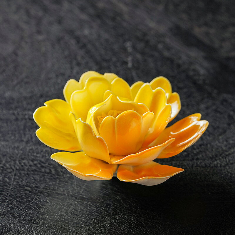 立体花びらの陶器製香立て 9タイプ 線香をすっきり立てて楽しめる、牡丹の花をモチーフにした陶器製のインセンスホルダーです。手作業で表情をつけた立体的な花びらと、タイプごとに異なる彩りが、卓上にやさしい華やかさを添えます。 線香を楽しむ時間のほか、お茶席や書斎、玄関、リビングの置物としても活躍。花のモチーフや手作りの器が好きな方への、性別を問わない日常使いのギフトにもおすすめです。 ■ 商品の特徴 線香を立てて使える、卓上用の香立てです。 陶器素材を使用し、線香の使用に適した耐熱性を備えています。 手作業で成形した花びらが、立体的な陰影を生み出します。 牡丹をモチーフにした花形デザインが、香立てを置物としても引き立てます。 タイプごとに花の彩りや表情が異なる、全9タイプ展開です。 お茶席、書斎、玄関、リビングなど、さまざまな場所に置けます。 線香を使わないときも、花のオブジェとして卓上を彩ります。 ■ 仕様 タイプ1 | タイプ2 | タイプ3 | タイプ4 | タイプ5 | タイプ6 | タイプ7 | タイプ8 | タイプ9 ■ 仕様 製法手作り タイプ全9タイプ サイズタイプにより異なります。 カラータイプにより異なります。 包装安全包装 素材陶器 用途線香立て、卓上の香立て デザイン立体的な花びらを表現した牡丹の花形 ■ おすすめシーン お茶席の卓上に。 書斎のデスクで香りを楽しむときに。 玄関に季節感のある置物を添えたいときに。 リビングのサイドテーブルや棚の彩りに。 線香を楽しむくつろぎの時間に。 花モチーフの小物を贈る日常のギフトに。 ※手作りのため、花びらの形、釉薬の色合い、サイズには個体差があります。※サイズは手作業による採寸のため、多少の誤差が生じる場合がございます。※線香使用時は、安定した耐熱性のある平らな場所に置き、火の取り扱いにご注意ください。※陶器製品のため、落下や強い衝撃を避けてください。※使用後は灰を取り除き、柔らかい布でやさしく拭いてください。※モニター環境により、実物と色味が異なる場合がございます。