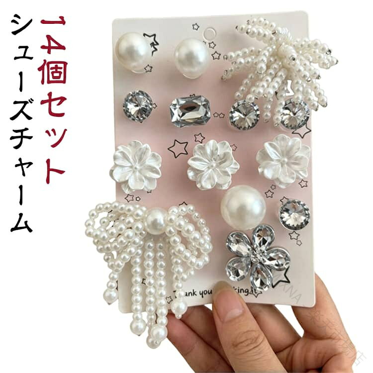 いつものクロッグサンダルが、一瞬でとびきりガーリーに変身！パールやビジュー、リボン、お花、そして立体的なバタフライを詰め込んだ、きらきら可愛いシューズチャームセットです。サンダルの穴にポチッと差し込むだけで、カジュアルな足元がパッと華やかで上品な印象に。ホワイトとクリアを基調としたデザインだから、どんなカラーのサンダルにもおしゃれにマッチします。気分や好みに合わせてパーツの配置を自由に変えられるのも嬉しいポイント。レディースはもちろん、おしゃれ大好きなキッズへのプレゼントにもおすすめです。 サイズ F サイズについての説明 F 素材 プラスチック 色 A(14個入り) 備考 ●サイズ詳細等の測り方はスタッフ間で統一、徹底はしておりますが、実寸は商品によって若干の誤差(1cm〜3cm )がある場合がございますので、予めご了承ください。 ●製造ロットにより、細部形状の違いや、同色でも色味に多少の誤差が生じます。 ●パッケージは改良のため予告なく仕様を変更する場合があります。 ▼商品の色は、撮影時の光や、お客様のモニターの色具合などにより、実際の商品と異なる場合がございます。あらかじめ、ご了承ください。 ▼生地の特性上、やや匂いが強く感じられるものもございます。数日のご使用や陰干しなどで気になる匂いはほとんど感じられなくなります。 ▼同じ商品でも生産時期により形やサイズ、カラーに多少の誤差が生じる場合もございます。 ▼他店舗でも在庫を共有して販売をしている為、受注後欠品となる場合もございます。予め、ご了承お願い申し上げます。 ▼出荷前に全て検品を行っておりますが、万が一商品に不具合があった場合は、お問い合わせフォームまたはメールよりご連絡頂けます様お願い申し上げます。速やかに対応致しますのでご安心ください。 【原産国／製造国: 中国】 .シューパーツ、靴飾り、靴用アクセサリー、DIY、シューズアクセサリー、シューズチャーム、靴用チャーム、花、クロッグサンダル用アクセサリー、パール、シューズデコ、リボン、ビジュー、キラキラ、おしゃれ、かわいい、レディース、キッズ、女性、靴デコレーション、飾りパーツ、サンダル小物、オリジナル、デコパーツ、シューズカスタムにおすすめ。人気の靴アクセサリーです。。 指定された配送時間は承っておりません。【MIXNA - 楽天市場店】