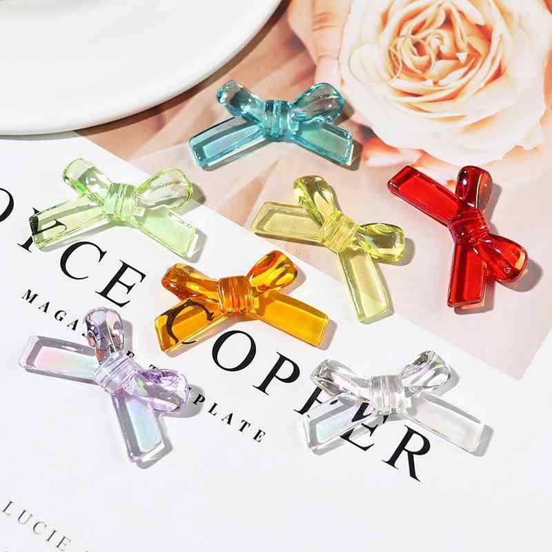 ・カテゴリ: ビーズ・素材: プラスチック、樹脂・加工方法: 電鍍・カラー展開: クリア、パープル、イエロー、グリーン、ブルー、オレンジ・デザインモチーフ: リボン