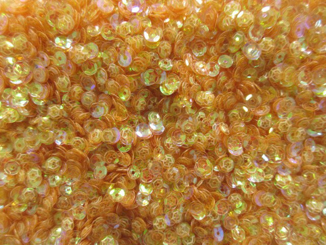 スパンコール　　亀甲　4mm（100g・25000枚）クリアオーロラ薄オレンジ系