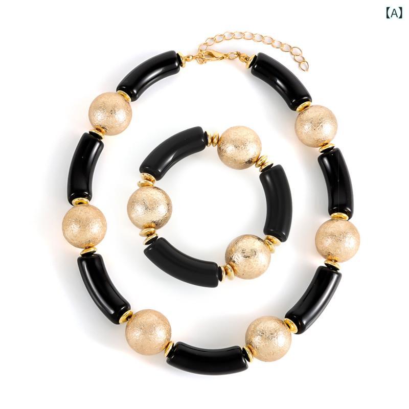 Necklace and bracelet set for women. Unique geometric design, bamboo joint ring, large bead ring, and chain. Gold and silver electroplated finish. Lightweight acrylic material. Perfect for winter fashion. Popular style combination.