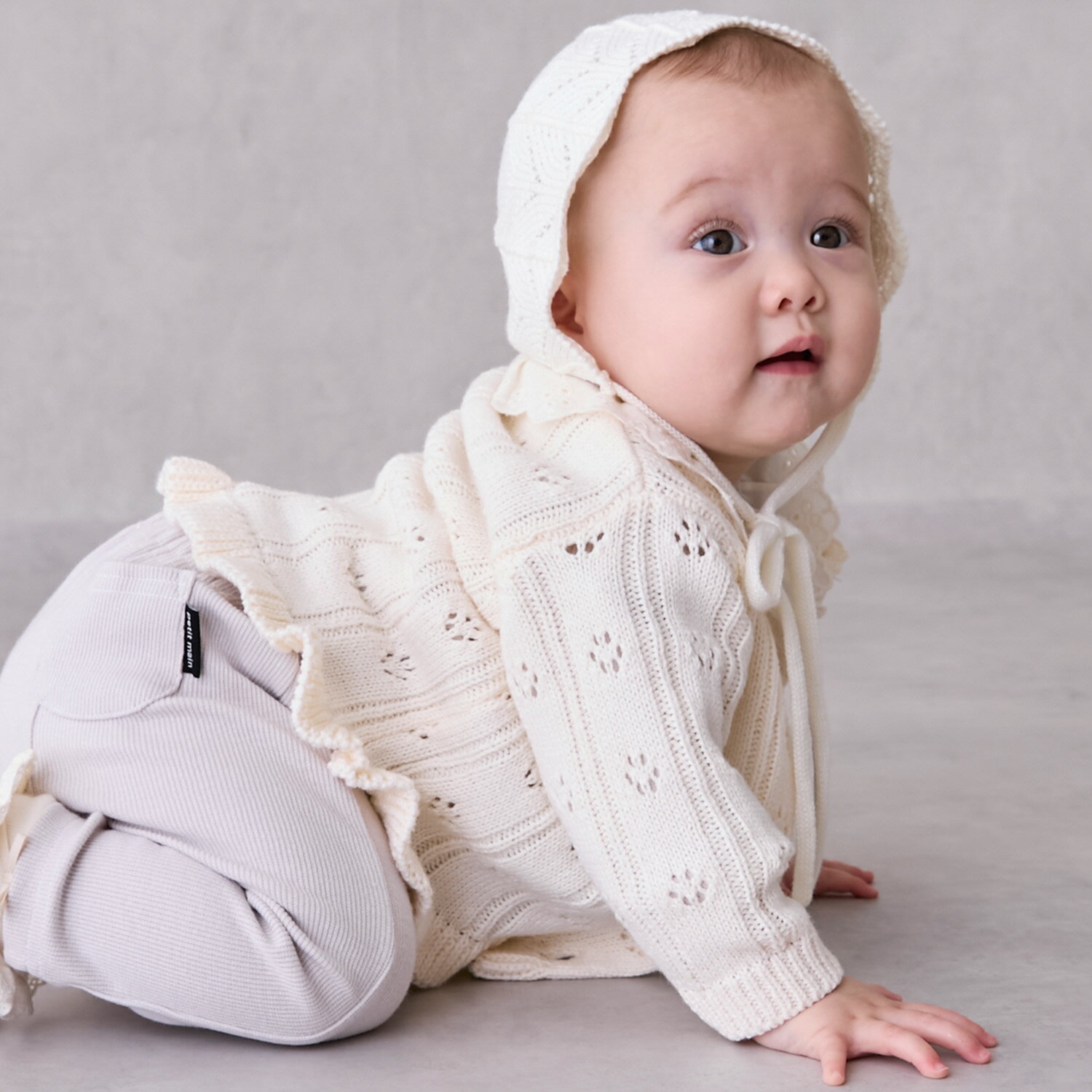 プティマイン(petit main)裾フリル針抜きカーディガン