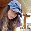野球帽は顔に見える小さいカウボーイのリボンの絆創膏の街の外に出す百合の野球帽です