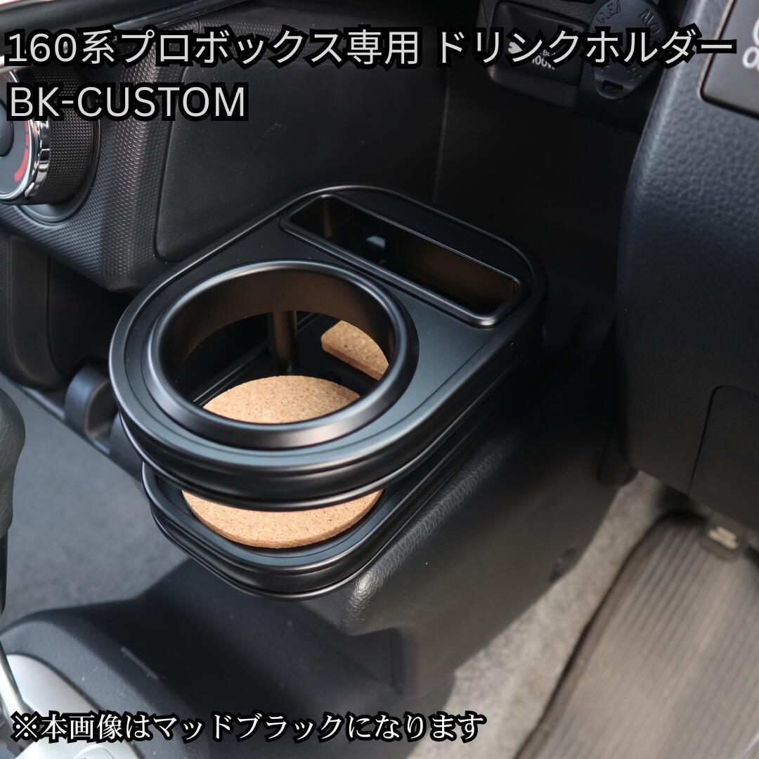 メッキの主張を削ぎ落とした、洗練のオールブラック。 トヨタ 160系 プロボックス / サクシード専用 フロントカップホルダー 【BK-CUSTOM】 ■ BK-CUSTOM（ブラック・カスタム）とは 通常のメッキモールや金属金具の主張をあえて抑え、モール・リング・固定ピンの細部に至るまで全て「ブラック仕様」に統一した特別ラインアップ。 ビジネスやカスタムベースとして絶大な人気を誇る160系プロボックス/サクシードの車内インテリアを引き締め、重厚感と一体感のあるシックな空間を演出します。 ■ 本商品の専用ホルダー仕様 ・スタイリッシュな丸型ドリンクホルダー × 1個 ・大型スマートフォンホルダー × 1個（標準装備） ※日常の業務やドライブで手元からスムーズに取り出せる、機能的でスマートなレイアウトです。 ■ 適合車種・型式 ・トヨタ：プロボックス / サクシード（160系） ・型式：NSP160V / NCP160V / NCP165V / NHP160V（ガソリン/ハイブリッド共通） ・年式：2014年9月〜現行（平成26年9月〜） ※商品画像のカラーはAIにて生成したイメージ画像のため、実際の質感・色味とは若干異なる場合がございます。また、お使いのディスプレイ環境によっても見え方が変わりますので予めご了承ください。メッキの主張を削ぎ落とした、洗練のオールブラック。 160系 プロボックス/サクシード専用 フロントカップホルダー 【BK-CUSTOM】 100%自社工場製造（日本製） / one creation オリジナルブランド ■ BK-CUSTOM（ブラック・カスタム）とは 通常のメッキモールや金属金具の主張をあえて抑え、モール・リング・固定ピンの細部に至るまで全て「ブラック仕様」に統一した特別ラインアップ。 ビジネスシーンからライフスタイルカスタムまで幅広く支持される160系プロボックス/サクシードのコックピットに自然と溶け込み、引き締まった上質な空間を演出するone creationこだわりの逸品です。 ■ BK-CUSTOM 5つのこだわりポイント 1. 細部まで徹底したパーツ黒化 モール、ドリンクホルダーリング、固定ピンまで全てブラックパーツを採用。ガチャガチャ感を排除したスタイリッシュな仕上げです。 2. 厳選された高級感ある6色天板 マットブラック / ピアノブラック / レザーブラック / ウッド / ブラックウッド / ブラックチェリー の6色からお好みに合わせて選択可能。 3. スマートで実用的なレイアウト インテリアと調和する「丸型ドリンクホルダー×1個」と、手元で操作しやすい「大型スマホホルダー×1個」を配置した機能的で使いやすい仕様です。 4. 車種専用設計による抜群のフィット感 160系プロボックス/サクシードのフロント部分へジャストフィット。専用設計ならではの高い一体感を提供します。 5. 安心の100%自社工場製造（日本製） 型取りから仕上げまで、熟練の職人が一つひとつ丁寧に自社工場で制作する高品質モデルです。 ■ 適合情報・商品仕様 適合車種 トヨタ プロボックス / サクシード 適合型式・年式 NSP160V / NCP160V / NCP165V / NHP160V（2014/09〜現行） パーツ仕様 オールブラック仕様（モール・リング・ピン黒化） ホルダー構成 丸型ドリンクホルダー × 1個 ＋ 大型スマホホルダー × 1個 天板カラー マットブラック / ピアノブラック / レザーブラック / ウッド / ブラックウッド / ブラックチェリー（全6色） 生産国 日本（100%自社工場にて製造） 【掲載画像・カラーに関するご注意】 ・商品ページ内に掲載しているカラー画像は、AIにて生成したイメージ画像となります。実際の製品とは微妙に色味や質感・光沢感が異なる場合がございます。 ・お客様がご利用のモニター、スマートフォン画面等の表示環境によっても見え方が変わりますので、あらかじめご了承ください。 ※受注生産品のため、ご注文確定後のキャンセル・変更はお受けできません。適合型式やカラーをよくお確かめの上ご注文ください。
